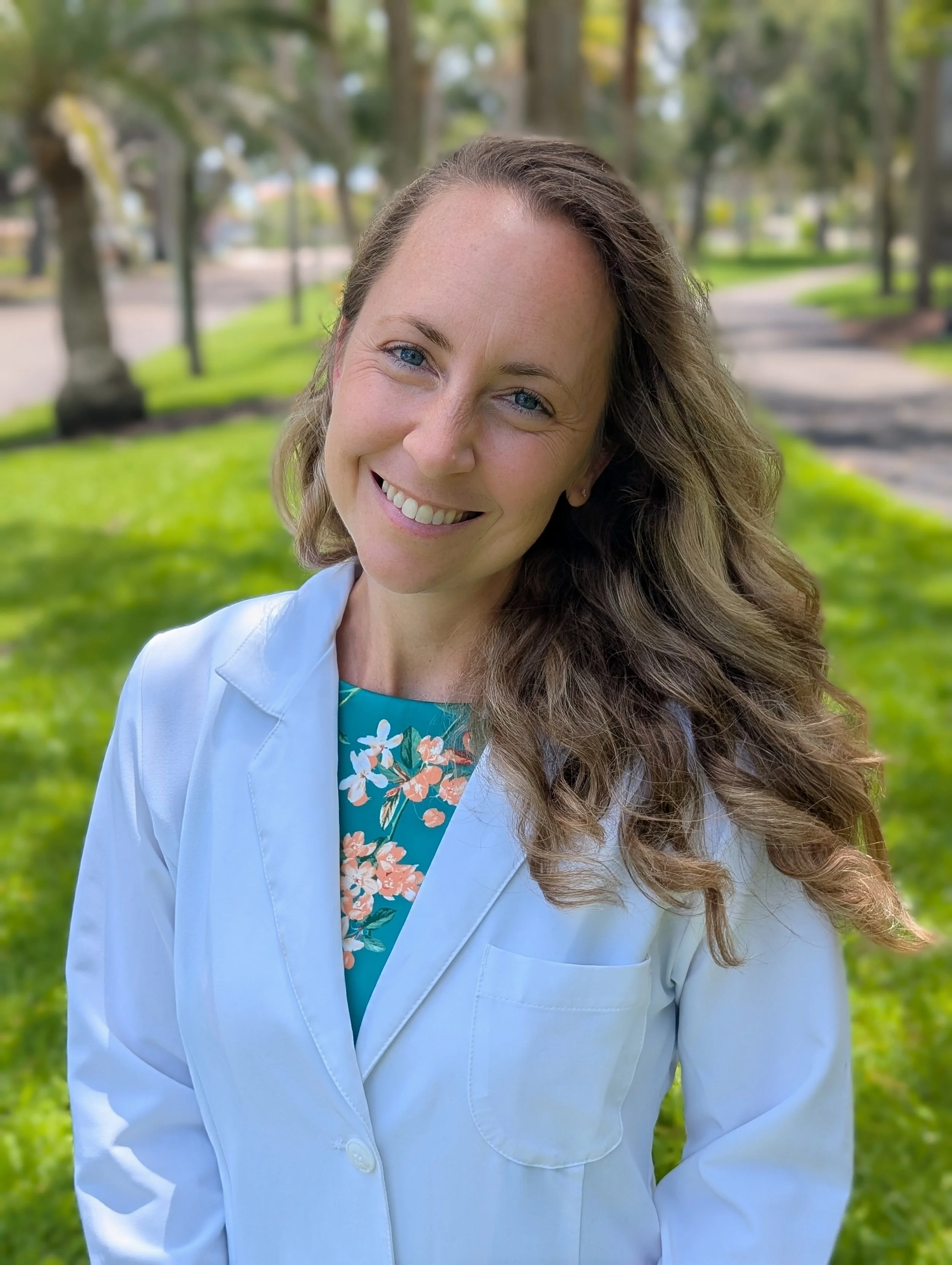 A smiling Dr. Josephine Olsen is seen. She is a concierge physician with Icon Medical and a Class 1 AME for FAA medical exams.