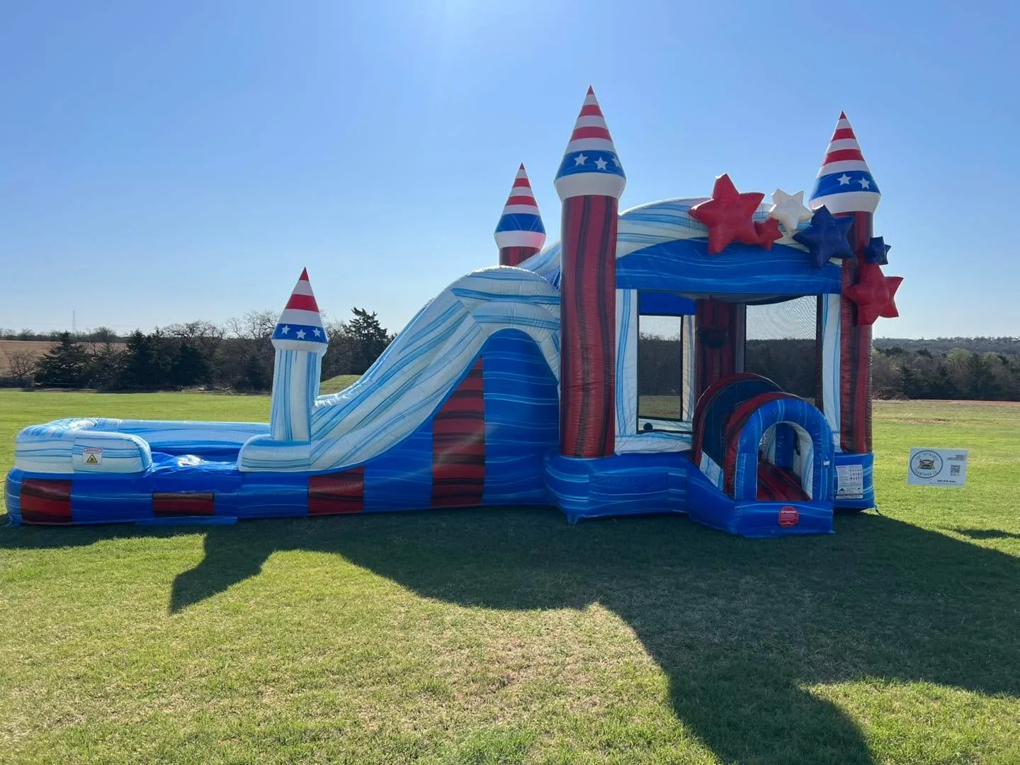 Another beautiful setup of our most popular inflatable- the Stars &amp; Stripes Combo! With bright, bold red, white, and blue marbling on the outside🇺🇸, a basketball hoop and climbing wall inside, and a fast, fun slide, this one is a statement piec