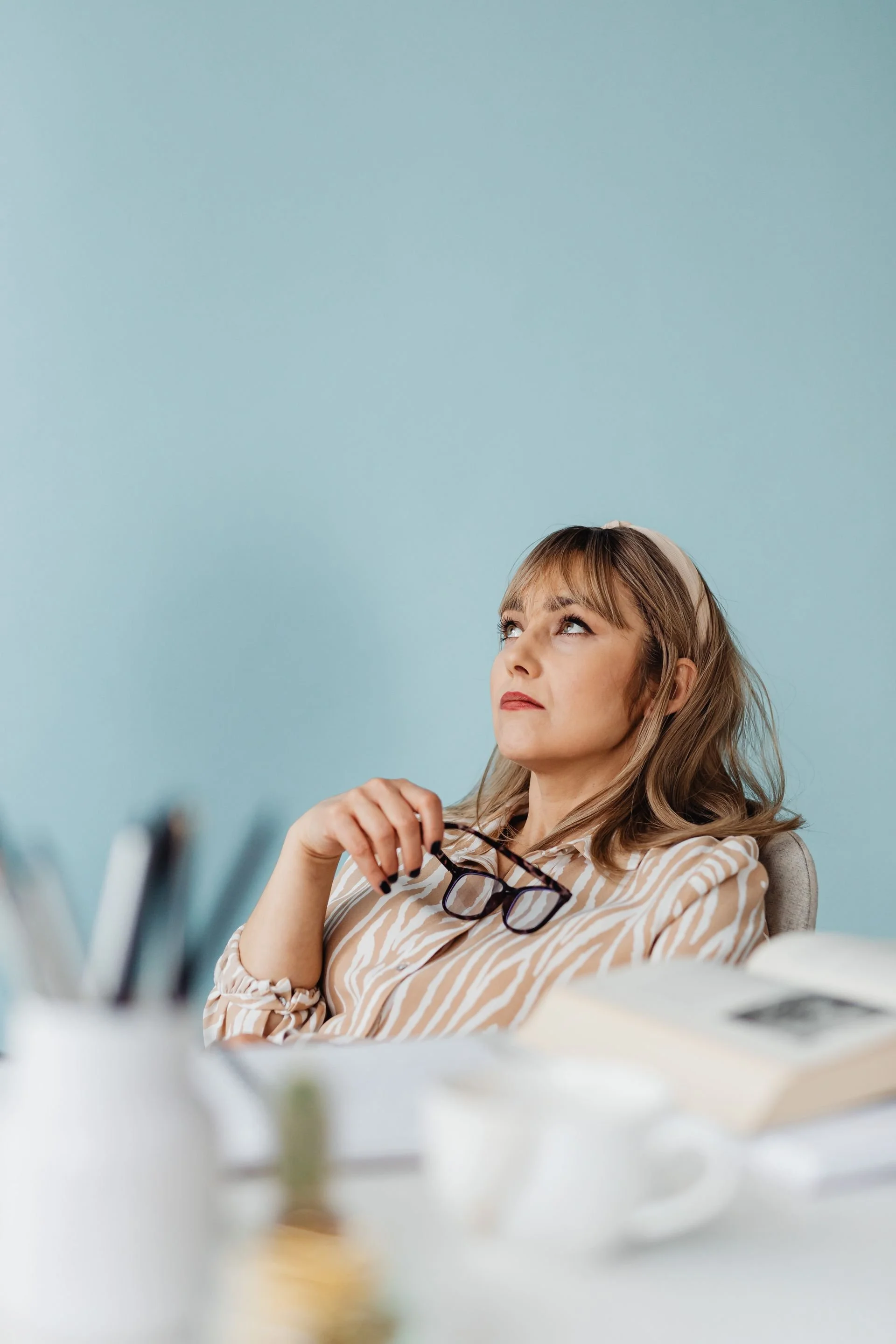 A stressed business owner looking upwards while managing executive burnout, representing the human cost of doing business handled by WellThera.