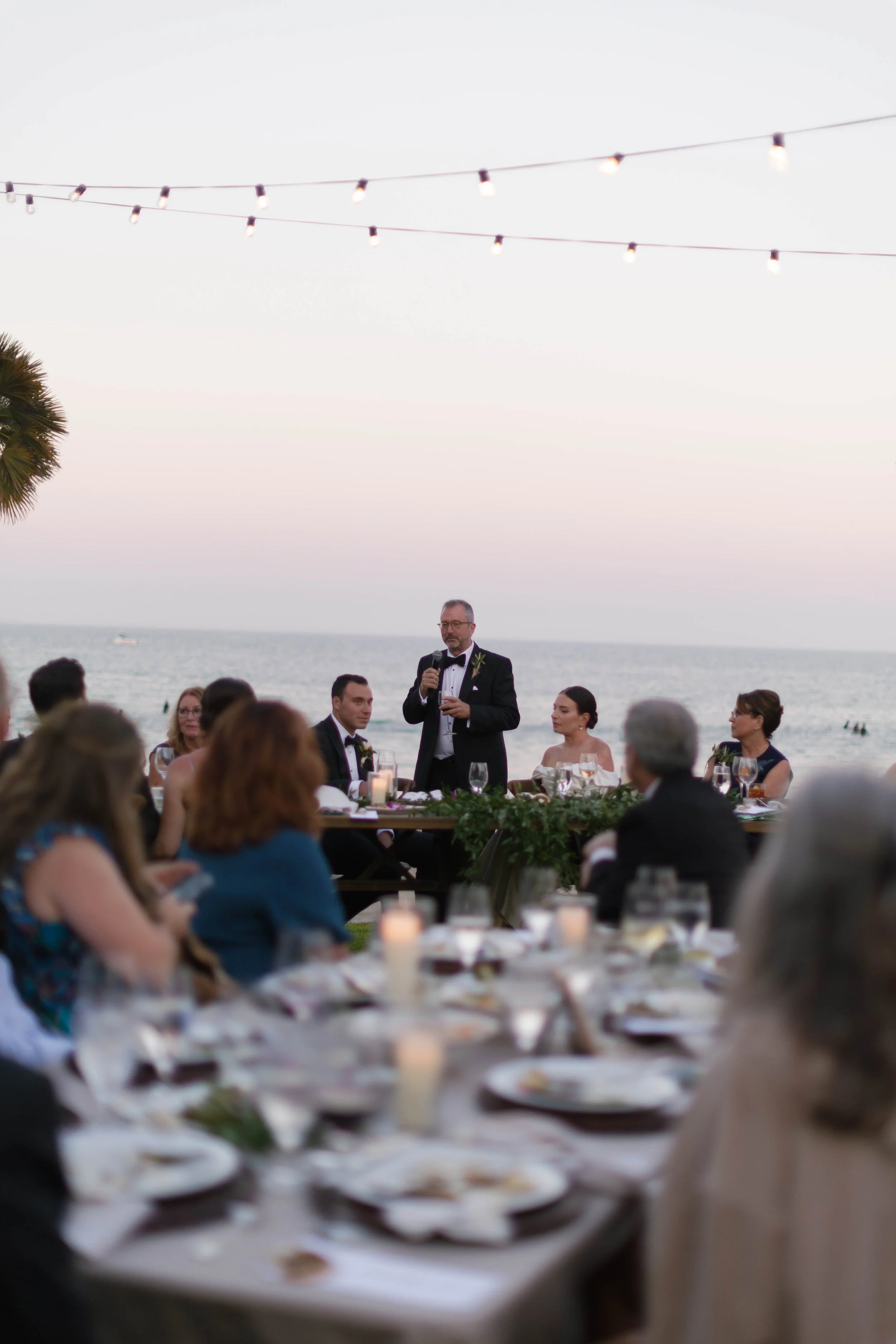 Father of the bride making a speech at dinner at sunset on the Adamson House Los Angeles California