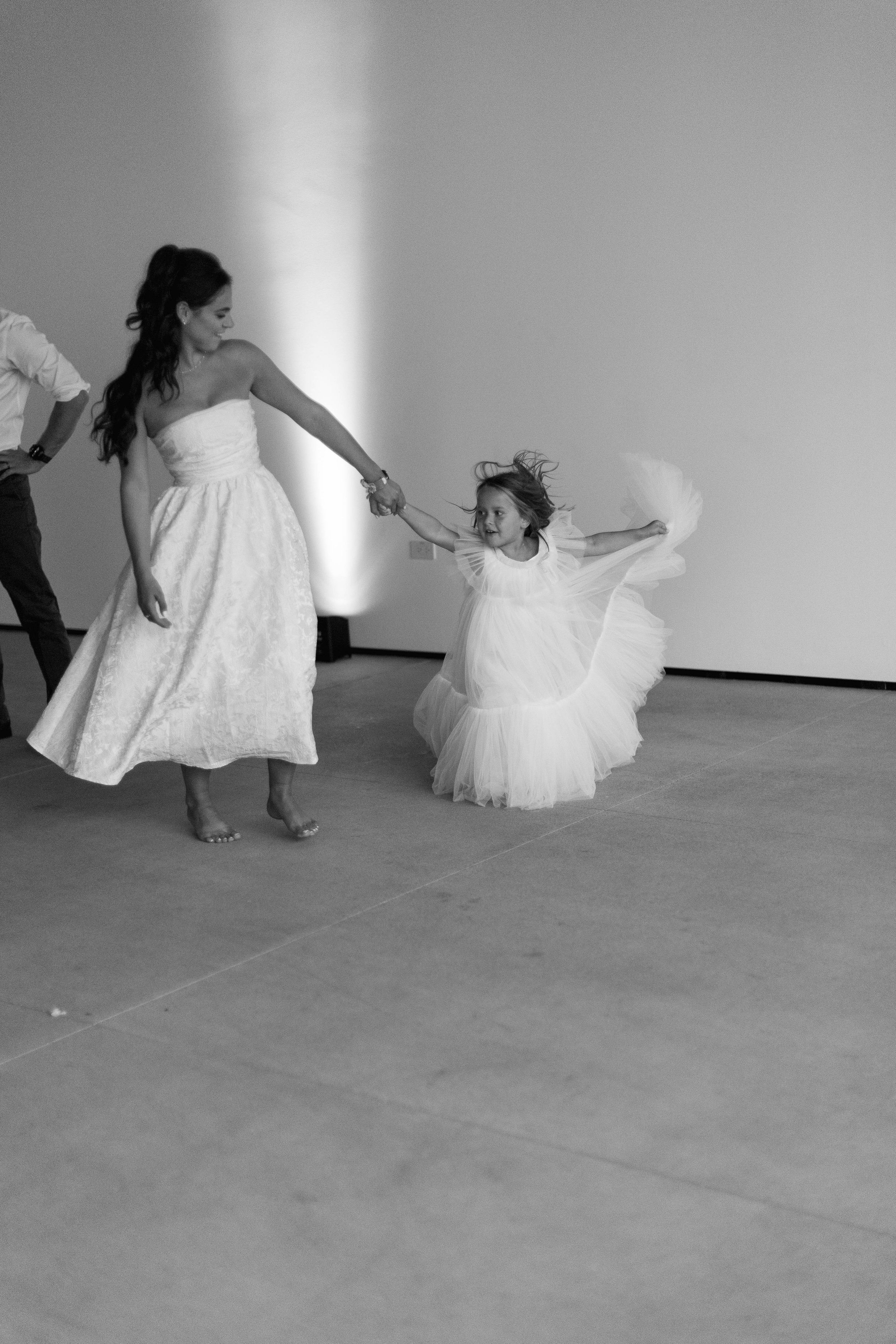 Flower girl dancing with a guest MCA San Diego