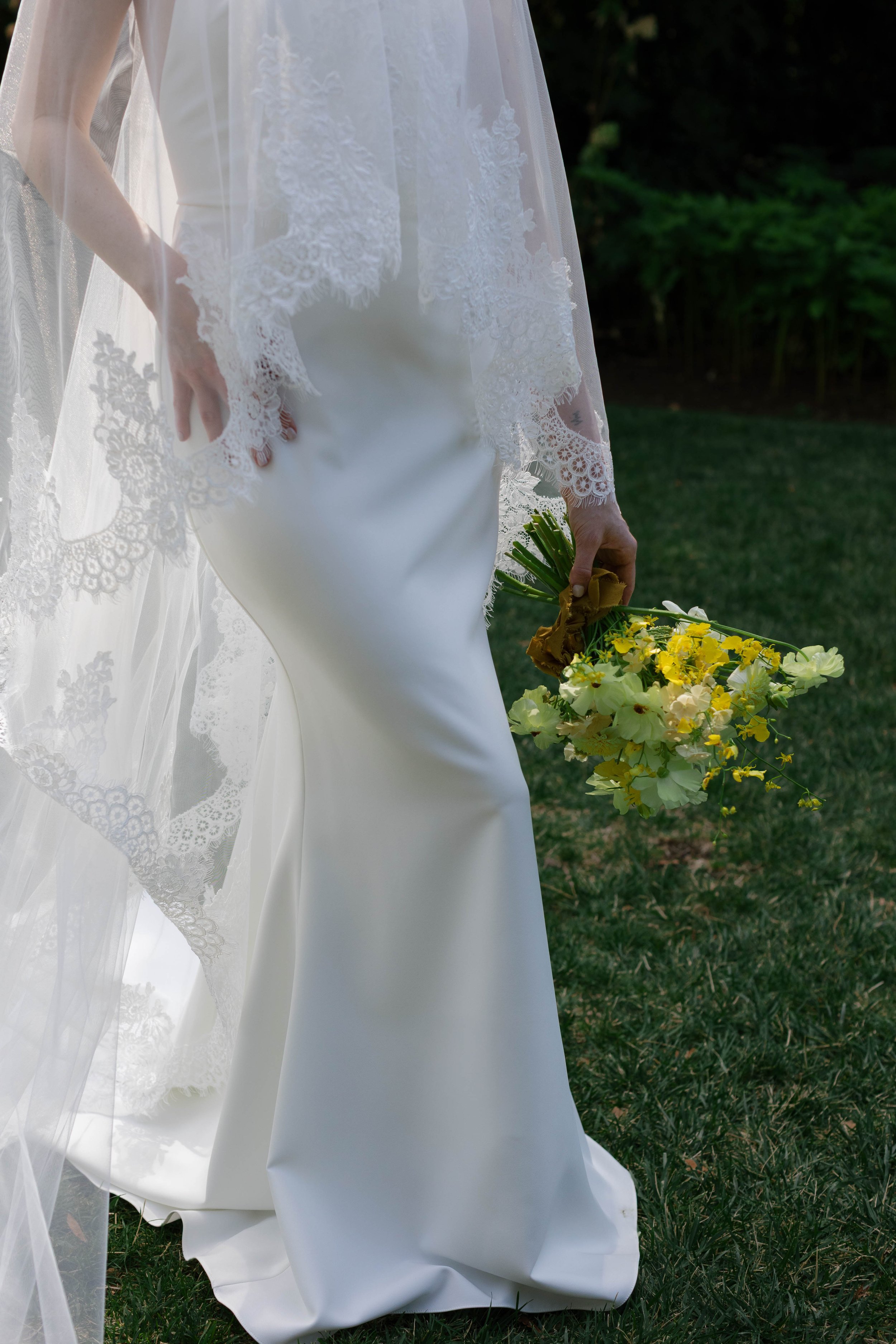 Details of a brides dress, veil, and bouquet at the Griffin House in the Gorge Oregon