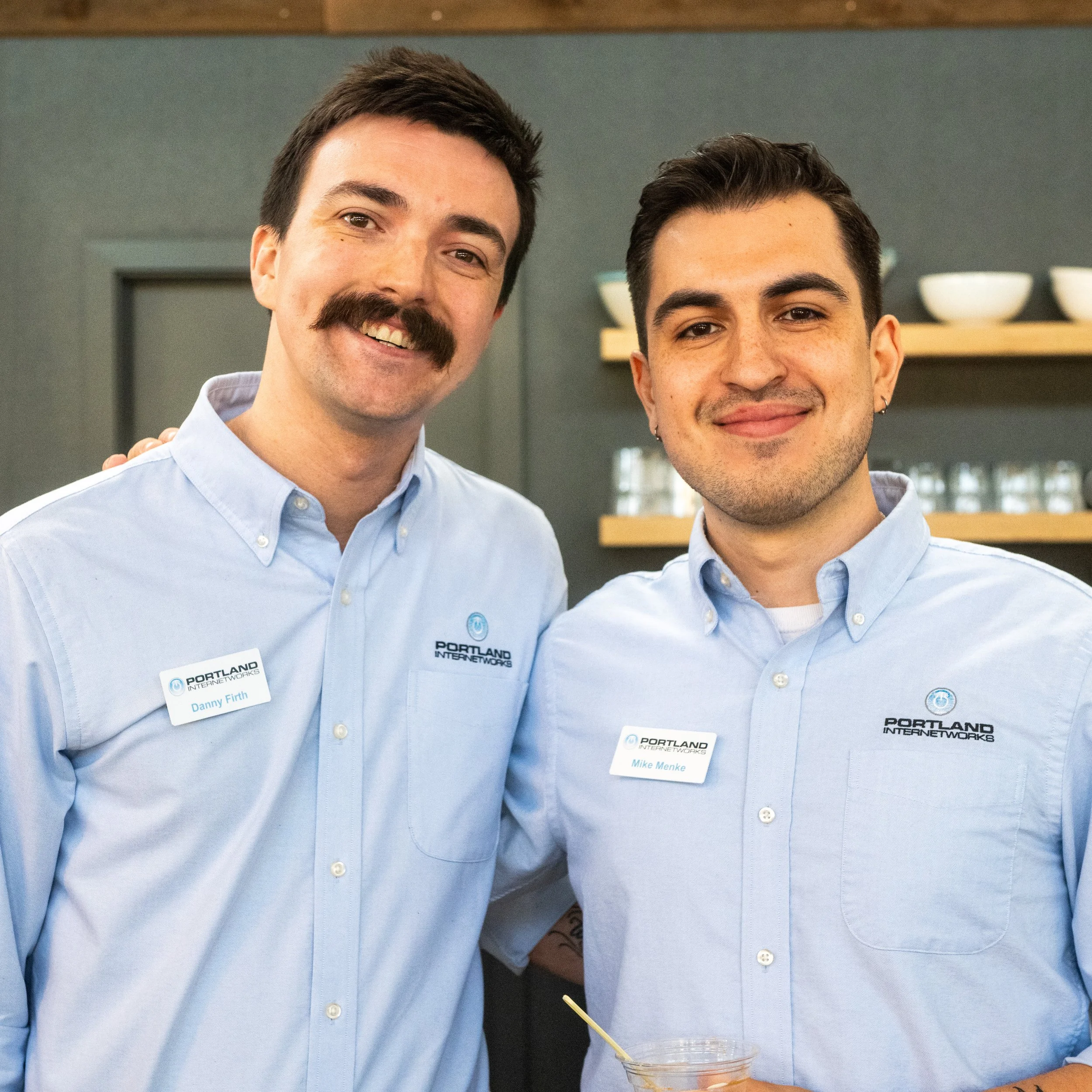 Two employees smiling at annual anniversary party
