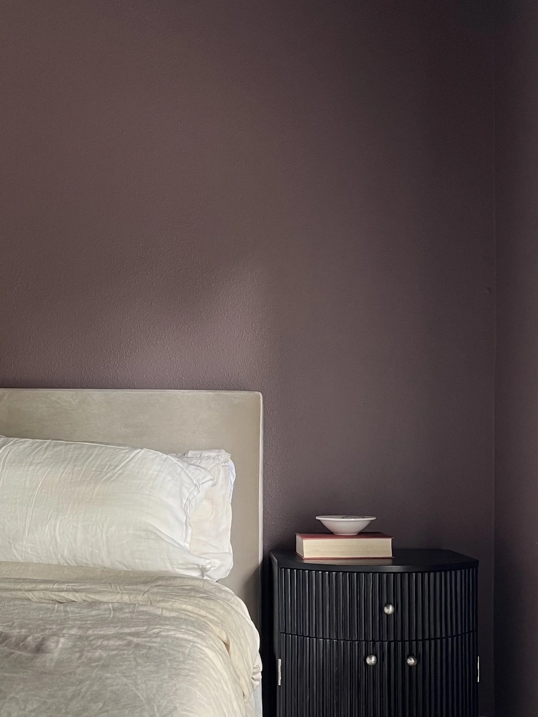 moody and luxurious primary bedroom color-drenched in a velvety plum.