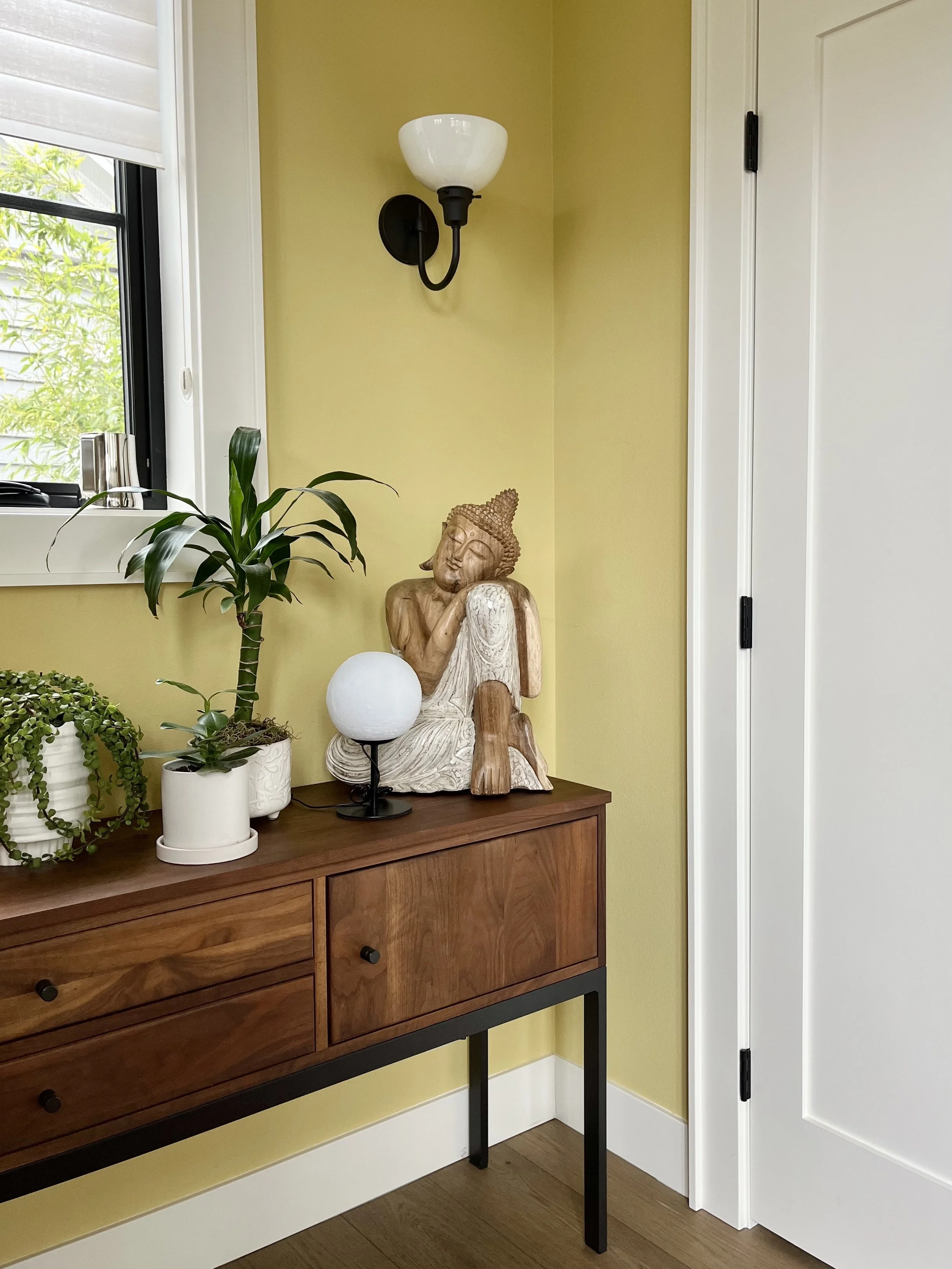 cheerful yellow entryway walls with white trim
