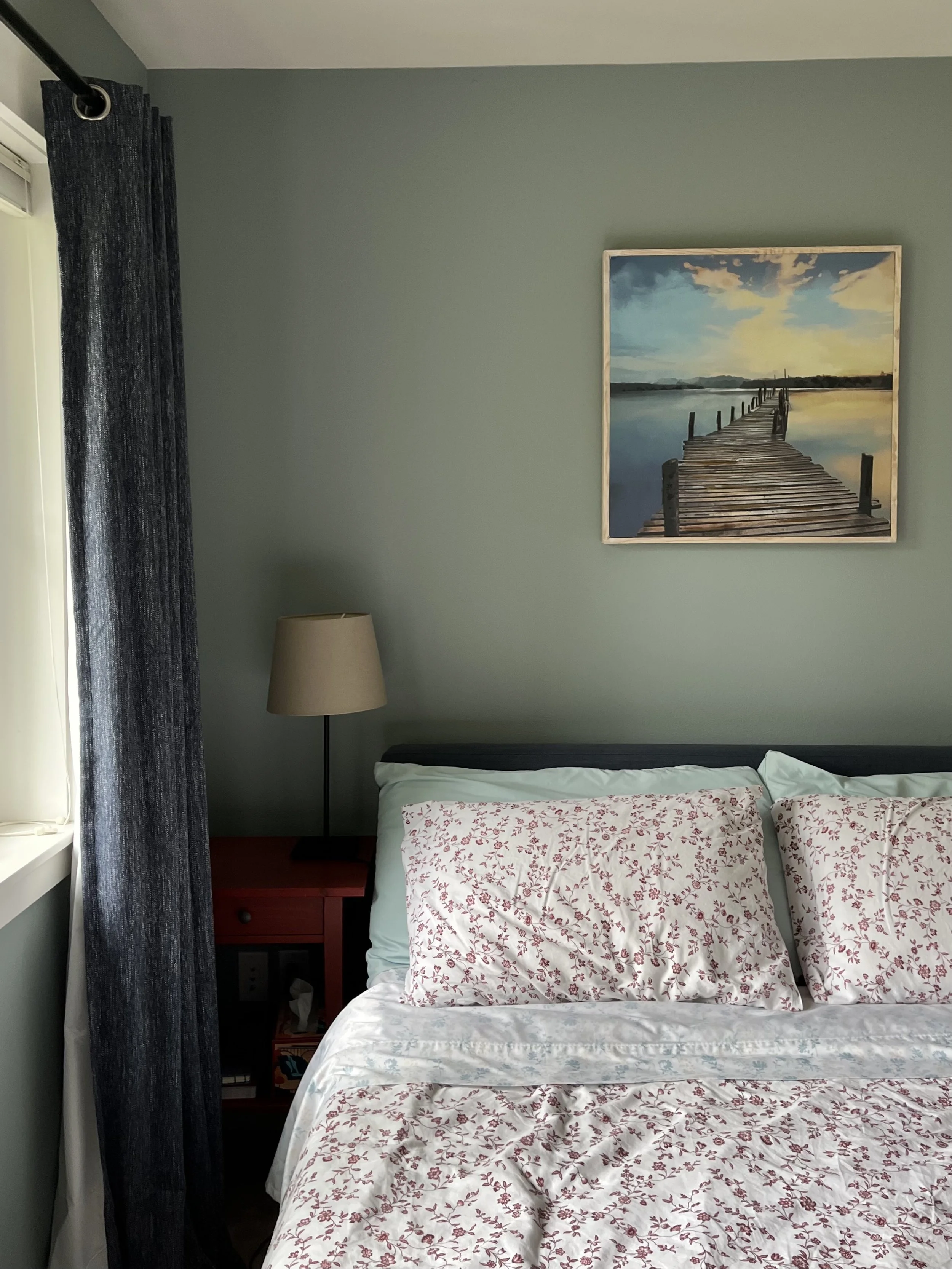 soft and airy blue guest bedroom paint color with red floral sheets and linen accents