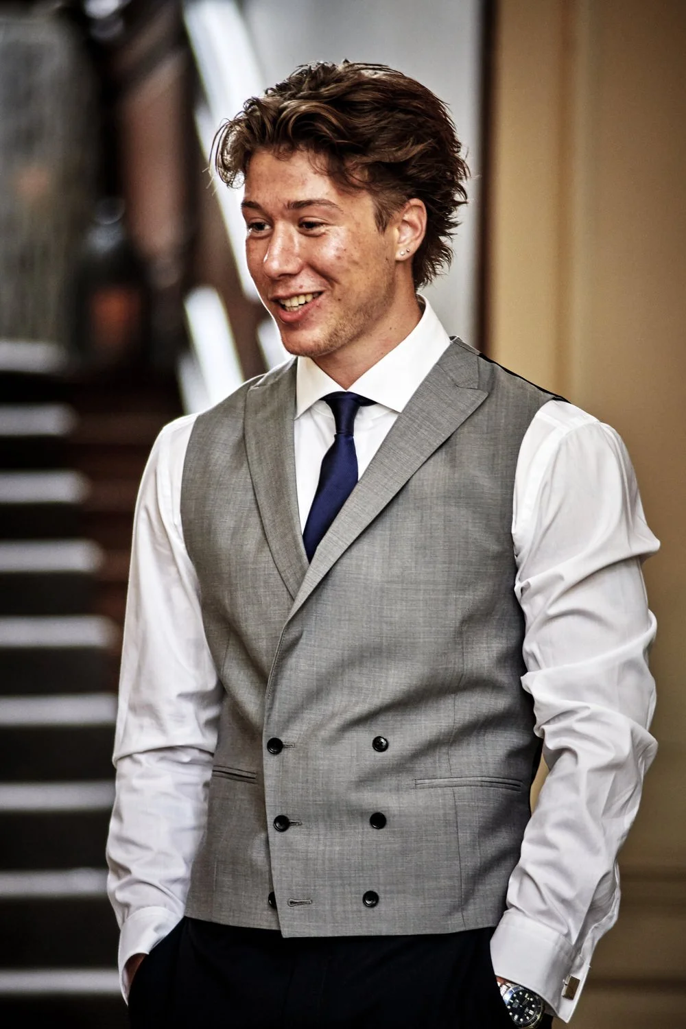 Best man stands in a waistcoat preparing to give his speech.