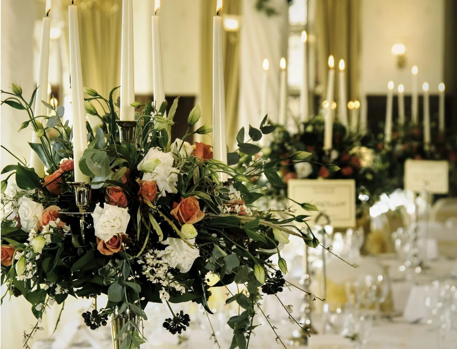 Close-up of a flower arrangement set in a beautiful large room.