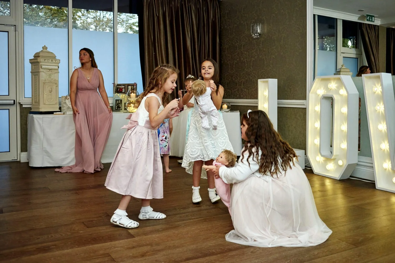 Children are the first on the dance floor and play with toy dolls.