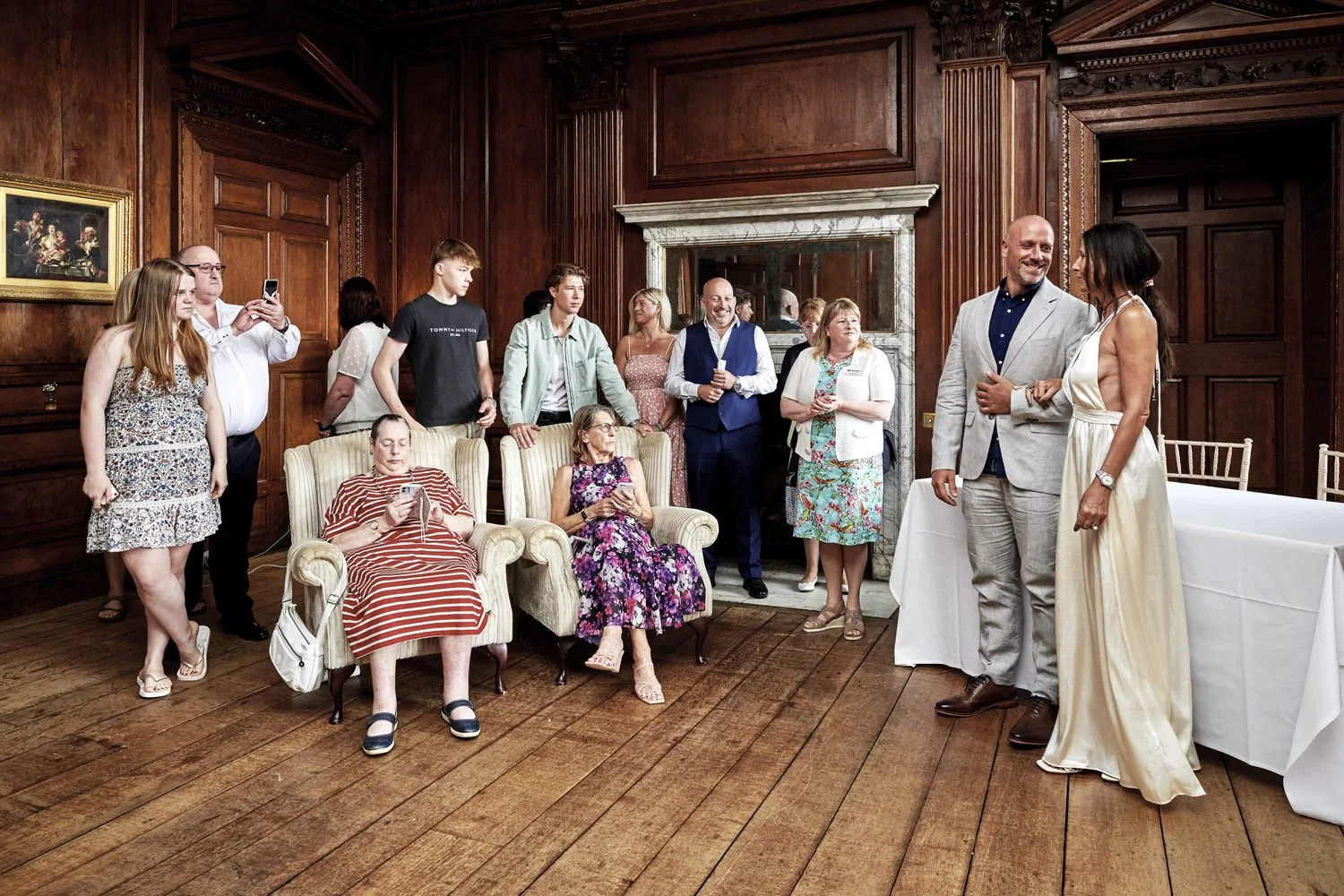 Couple stand at altar with family and friends seated with them.