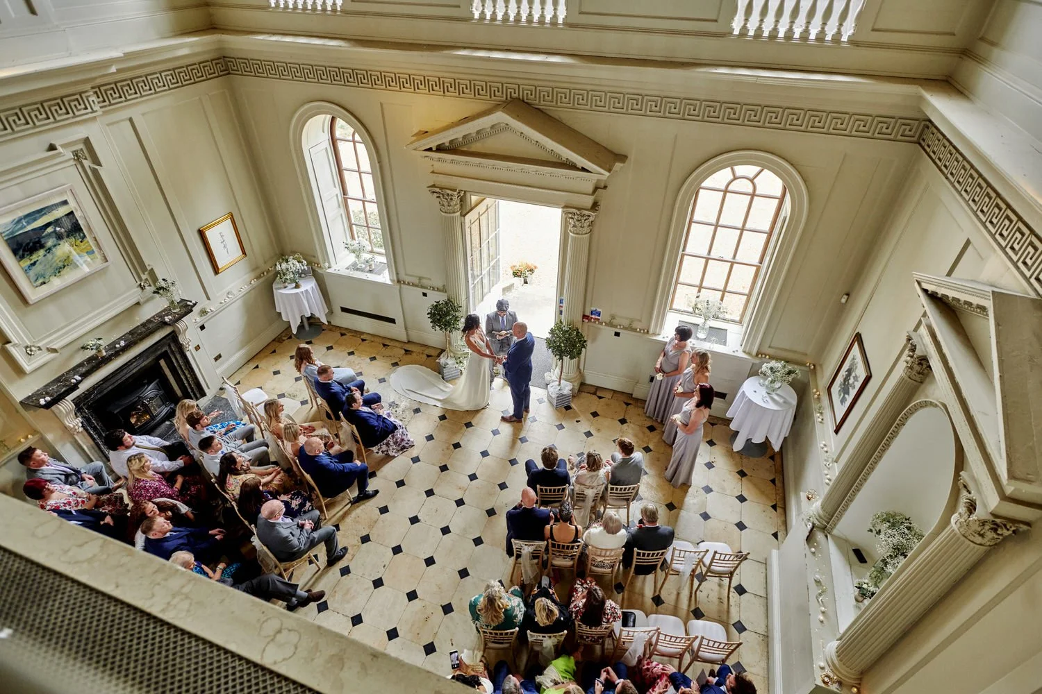 A view of a wedding ceremony taken from a high balcony as the couple are married.