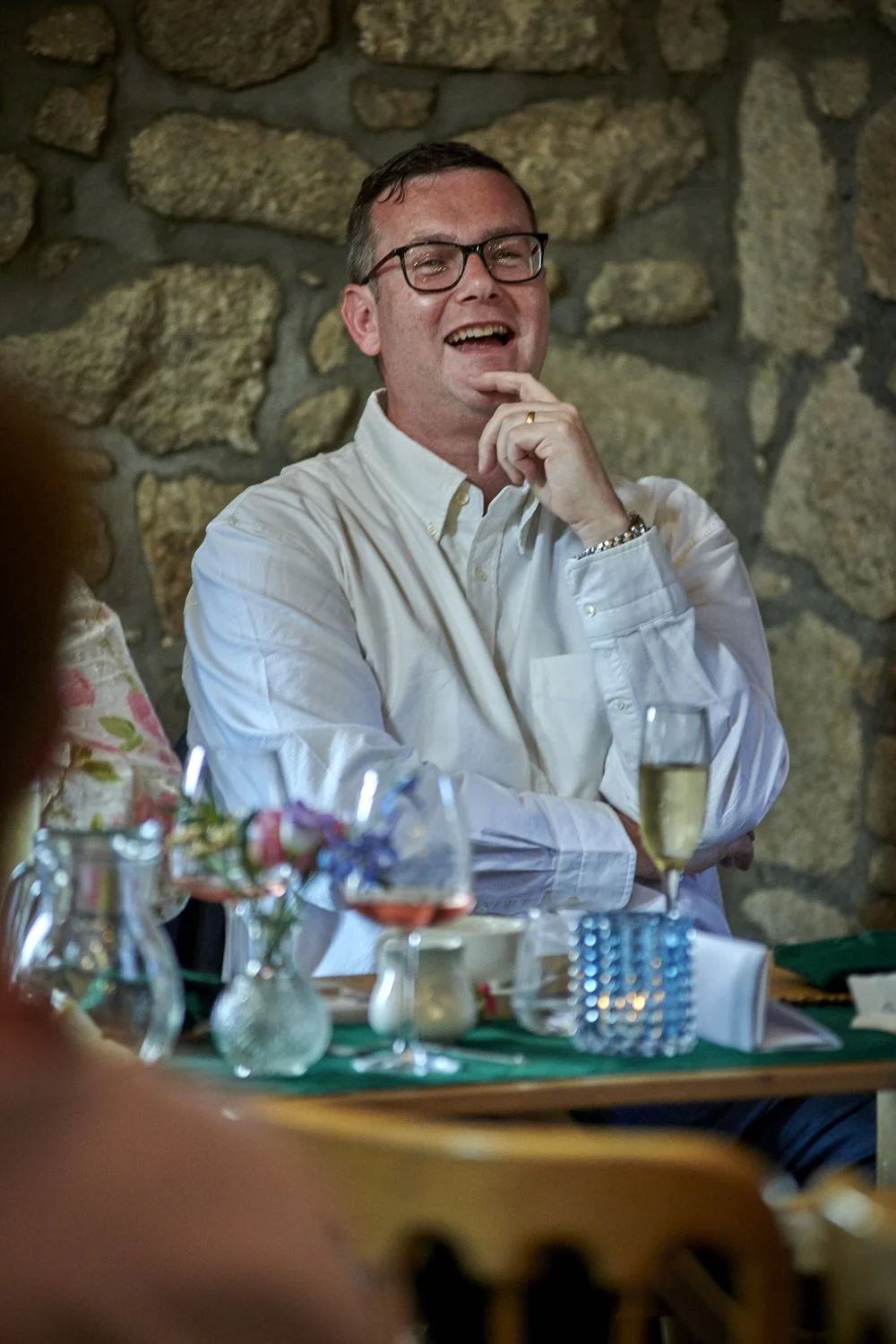 Father of the bride looks thoughtful as he sits at the top table.