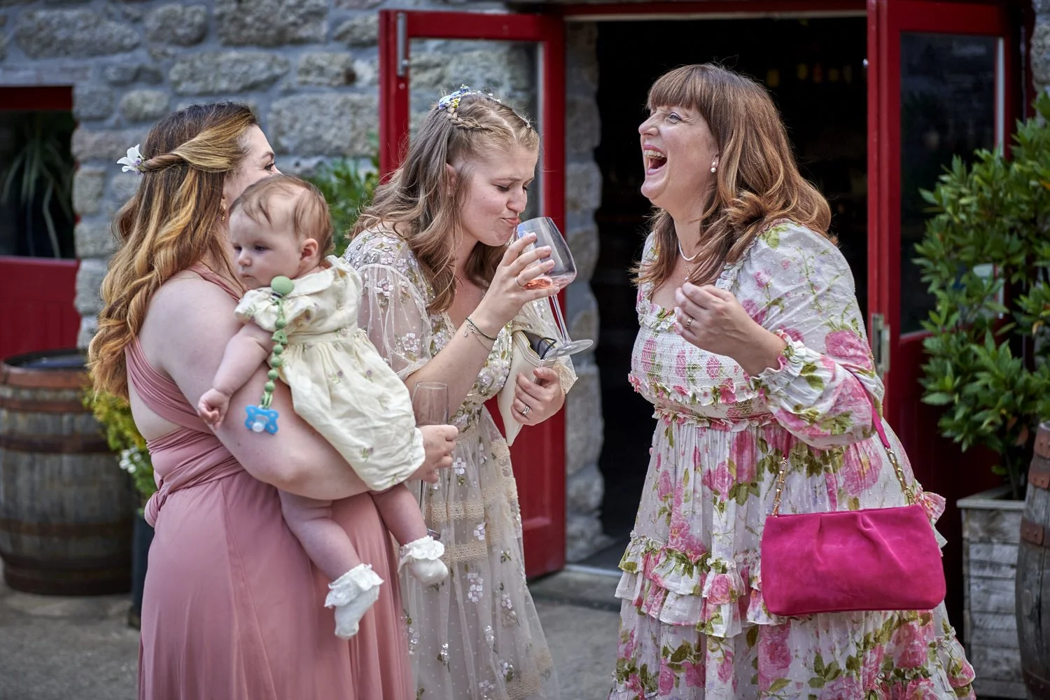 Mother of the bride and bride laugh together as the evening party begins.