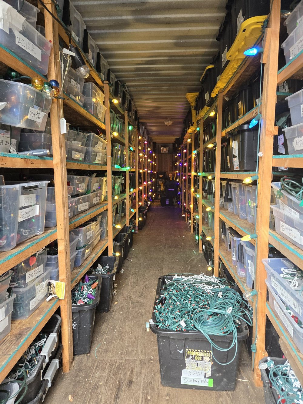 Rows of labeled storage bins holding customers' custom-fit Christmas lights