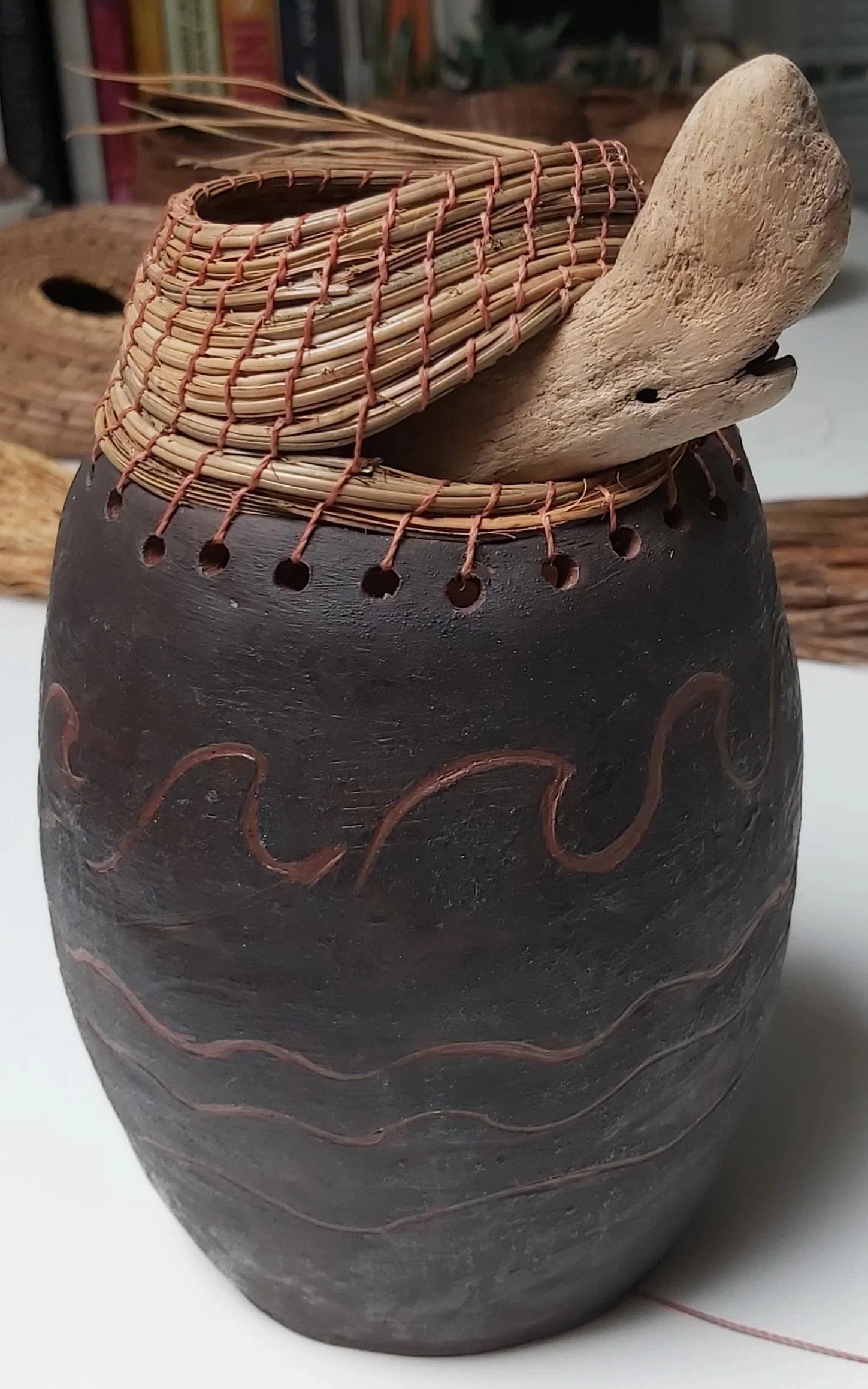 Pottery and driftwood. The whale.