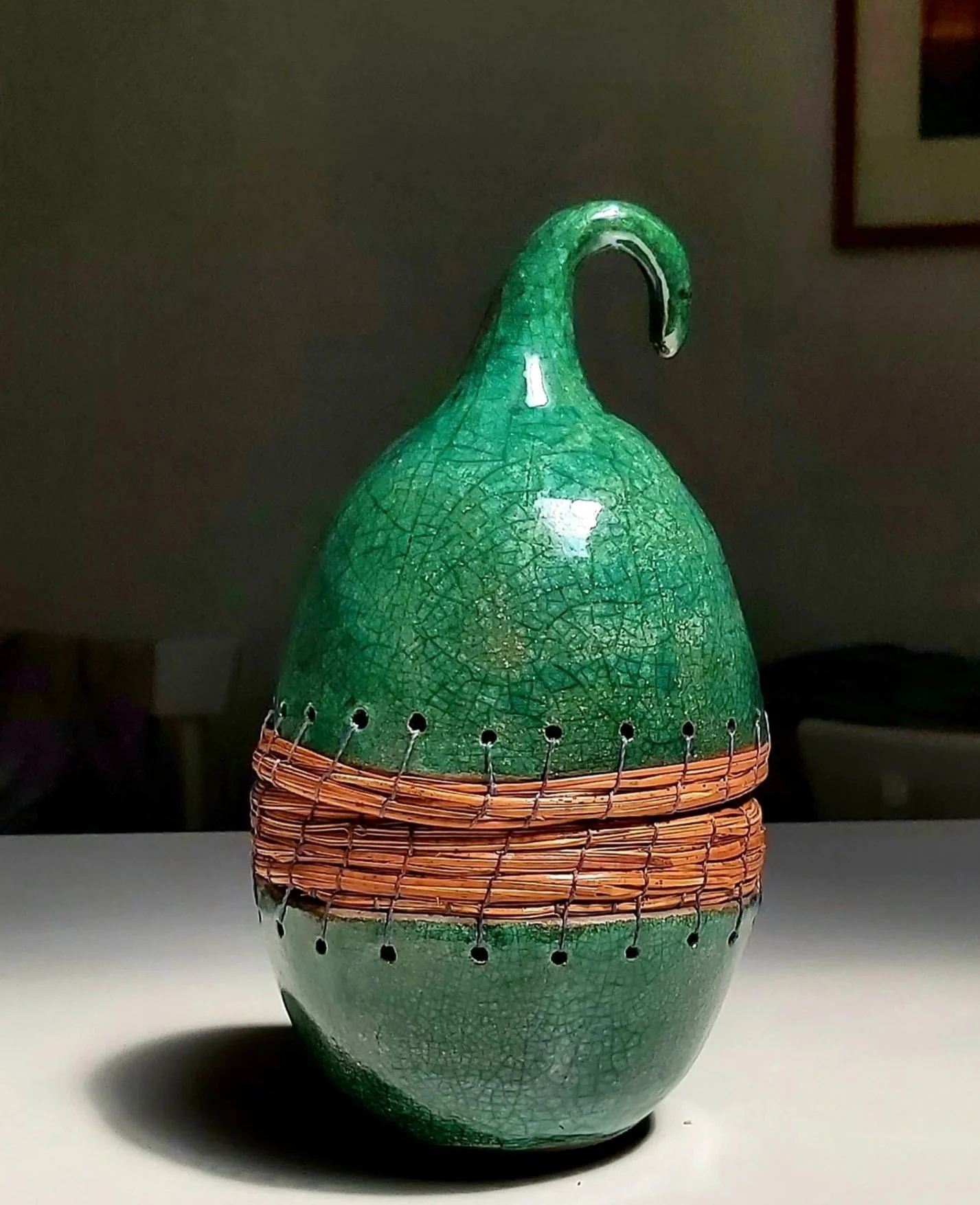 A green pod - raku fired pottery  and pine needles