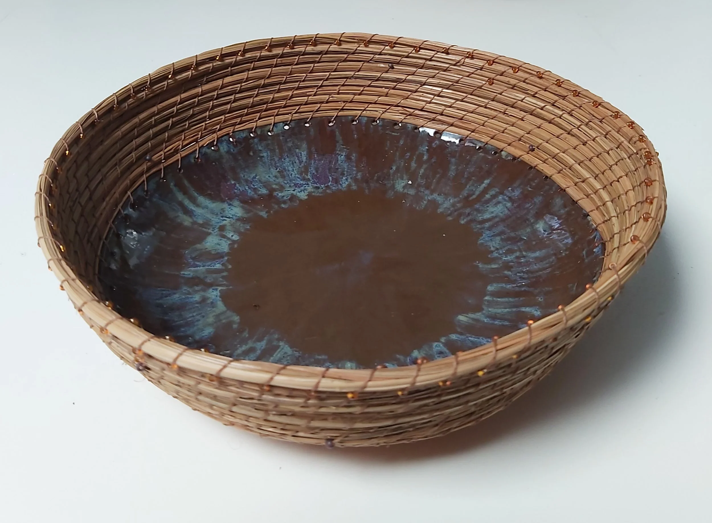 Pottery base with pine needles.