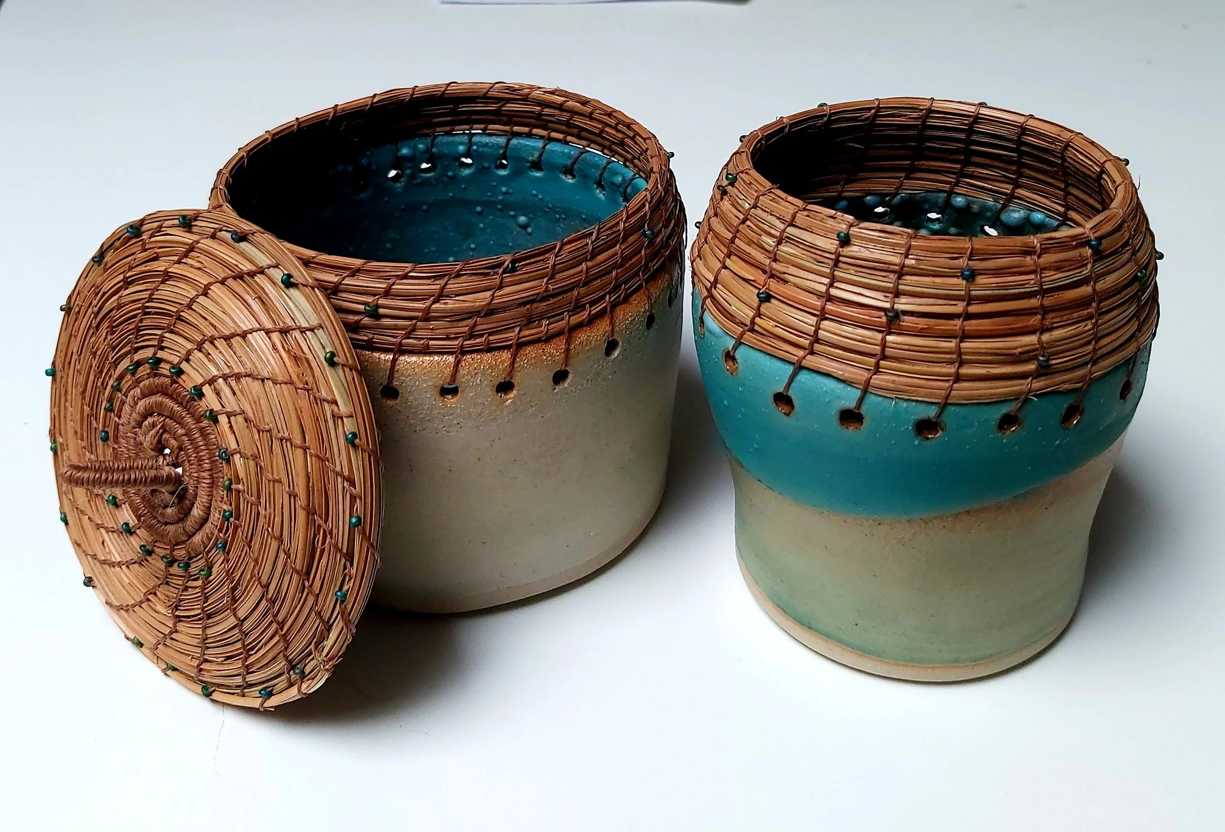Stoneware, pine needles, some with lids.