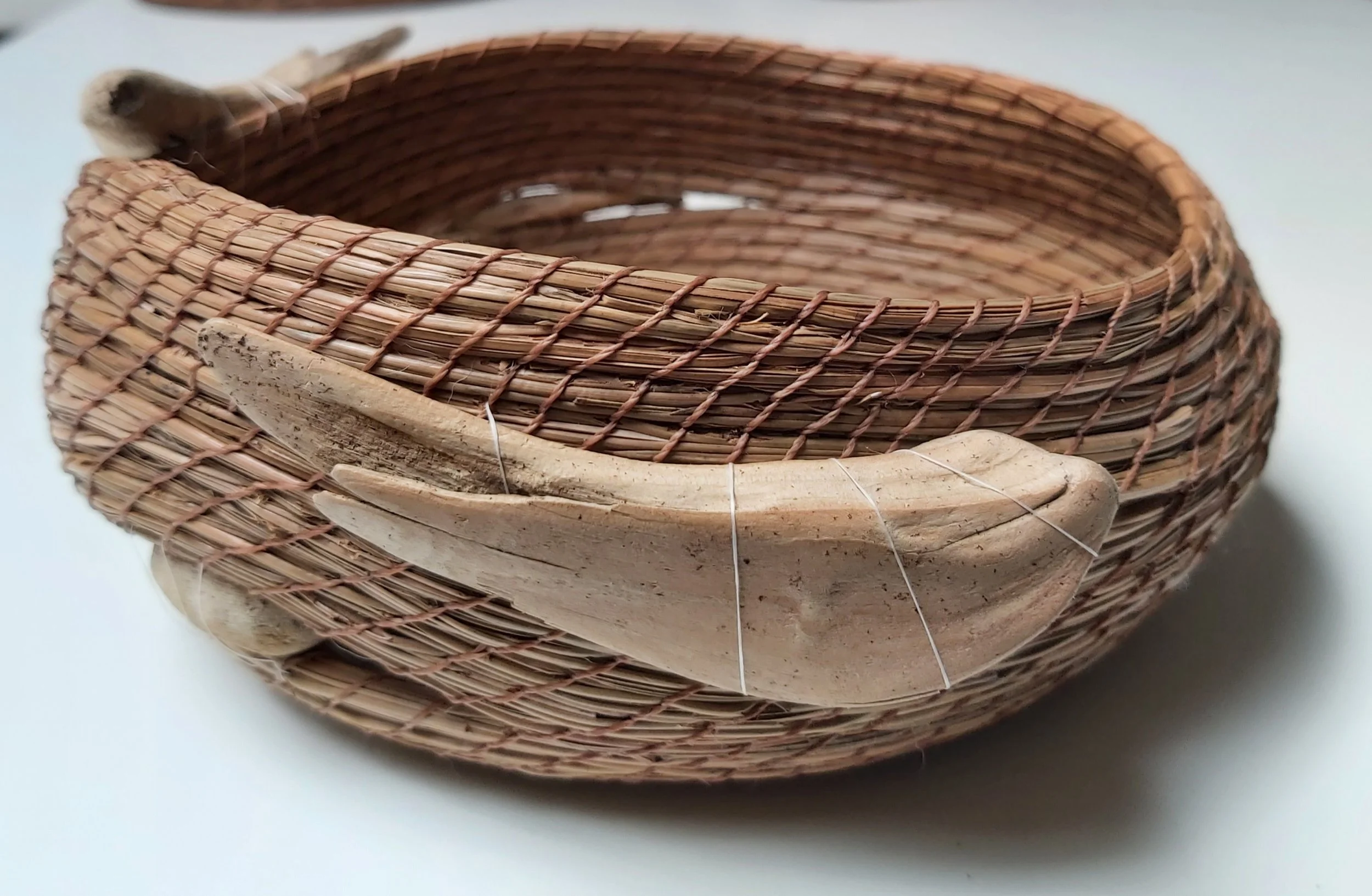 Basket with driftwood collected in Gaspesie, Quebec. They are wonderfully soft and resemble little birds or fish.