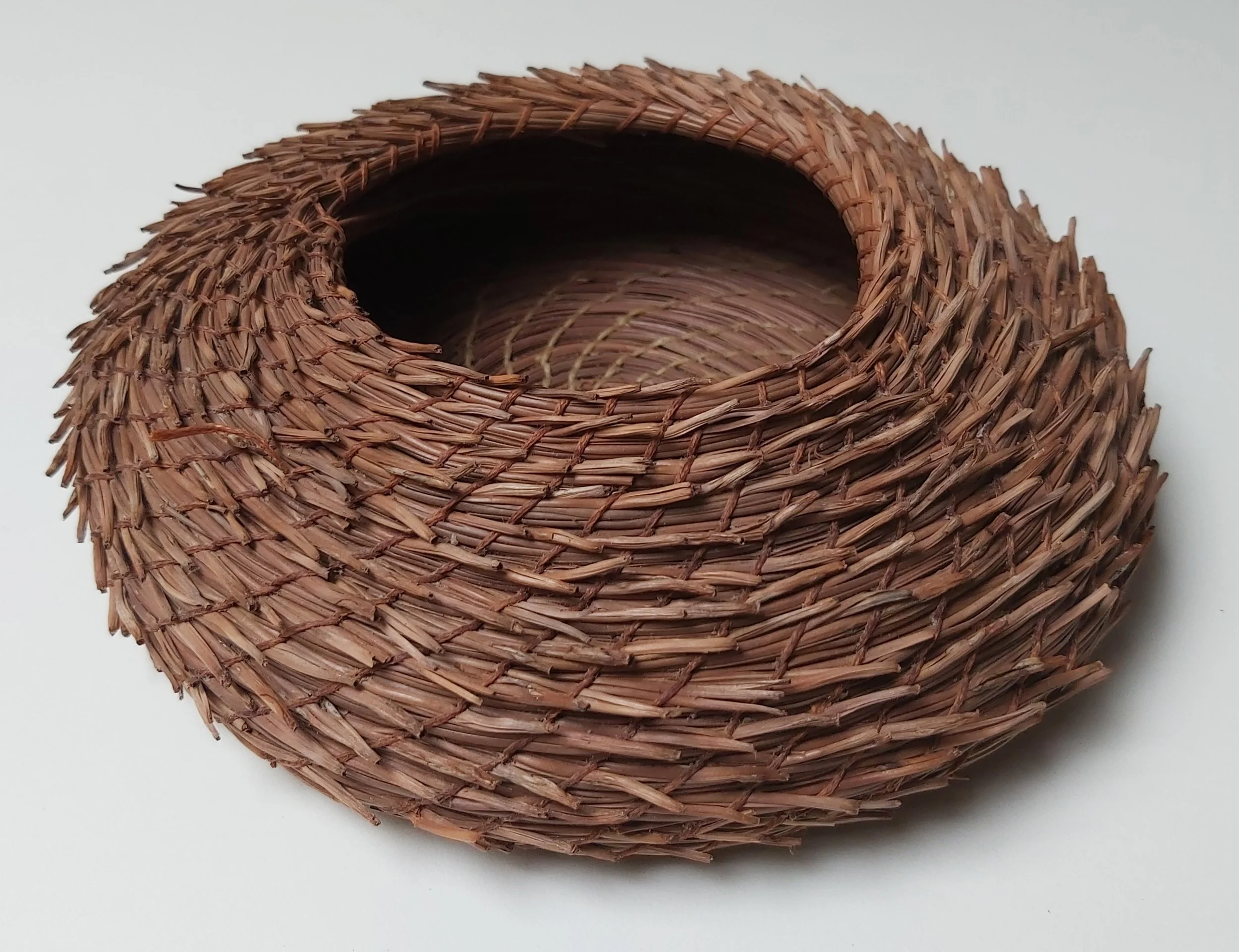 The hedgehog. Instead of tucking the end of the pine needles in the coil, they are left to stick out. Very fiddly to stitch!