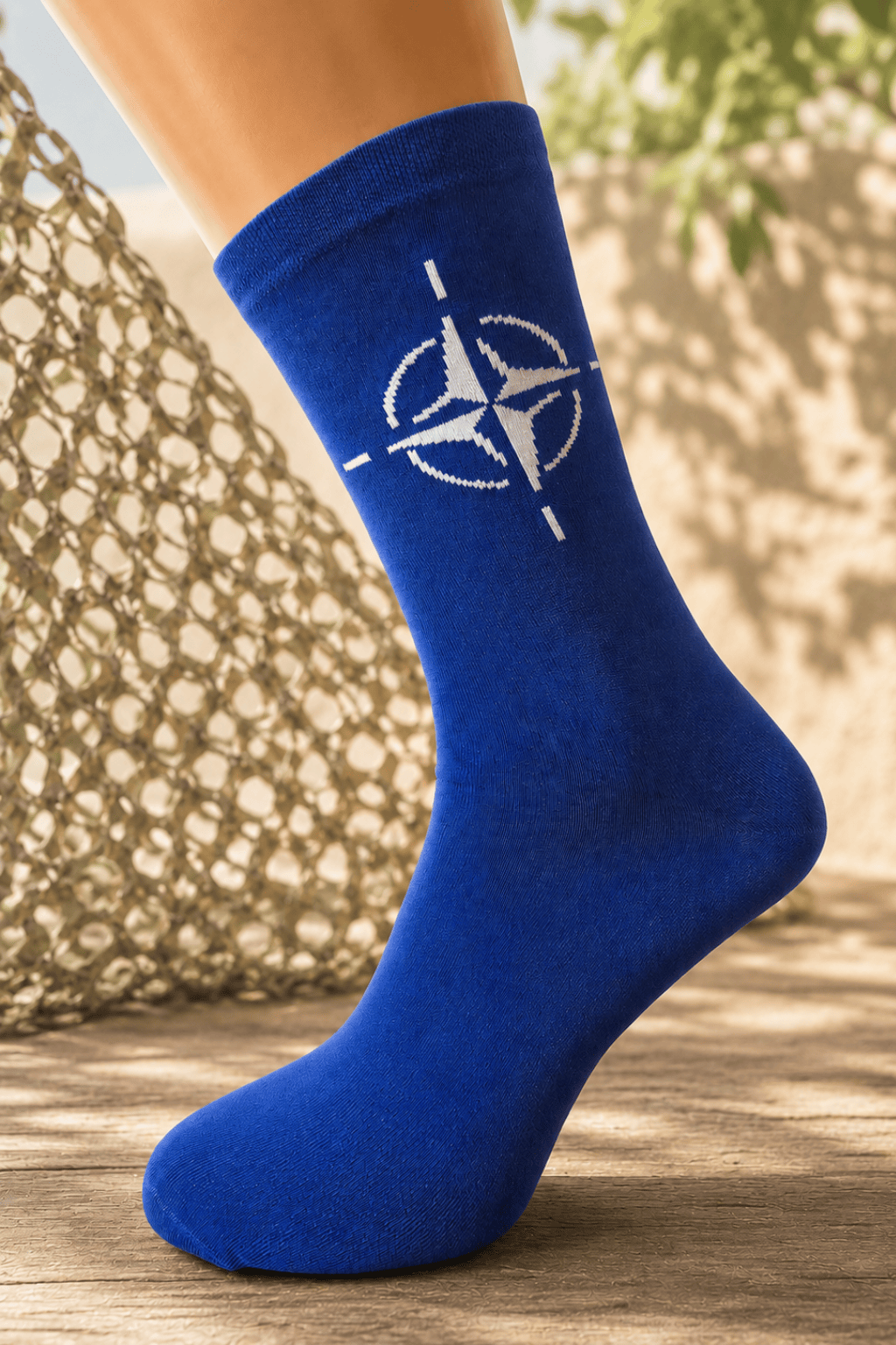 Blue socks with NATO emblem with military field in the background
