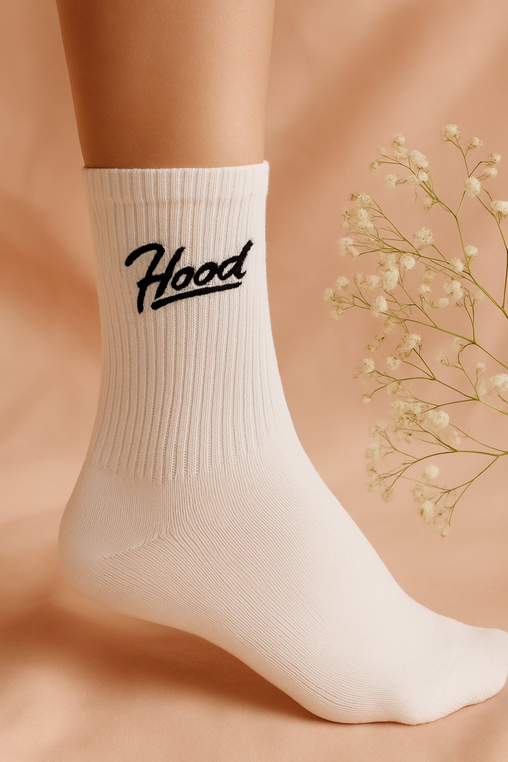 White socks with "Hood" design written on them