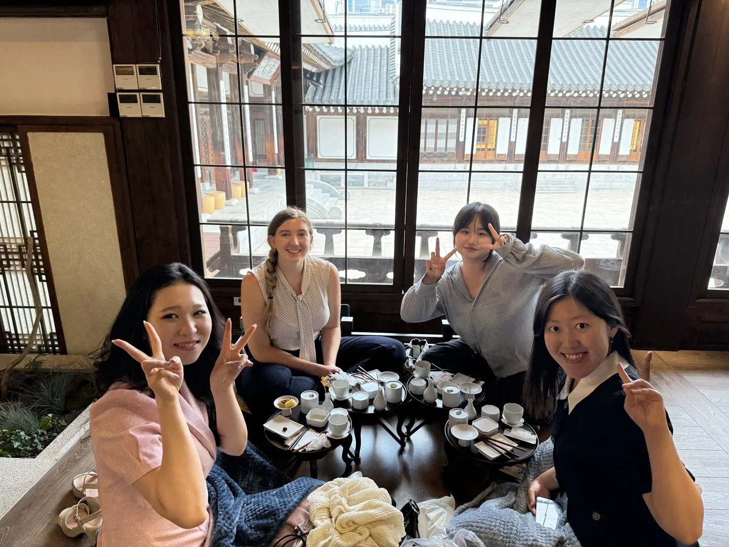 KASC delegates share tea and conversation in a traditional Korean teahouse, experiencing cultural immersion and hospitality.