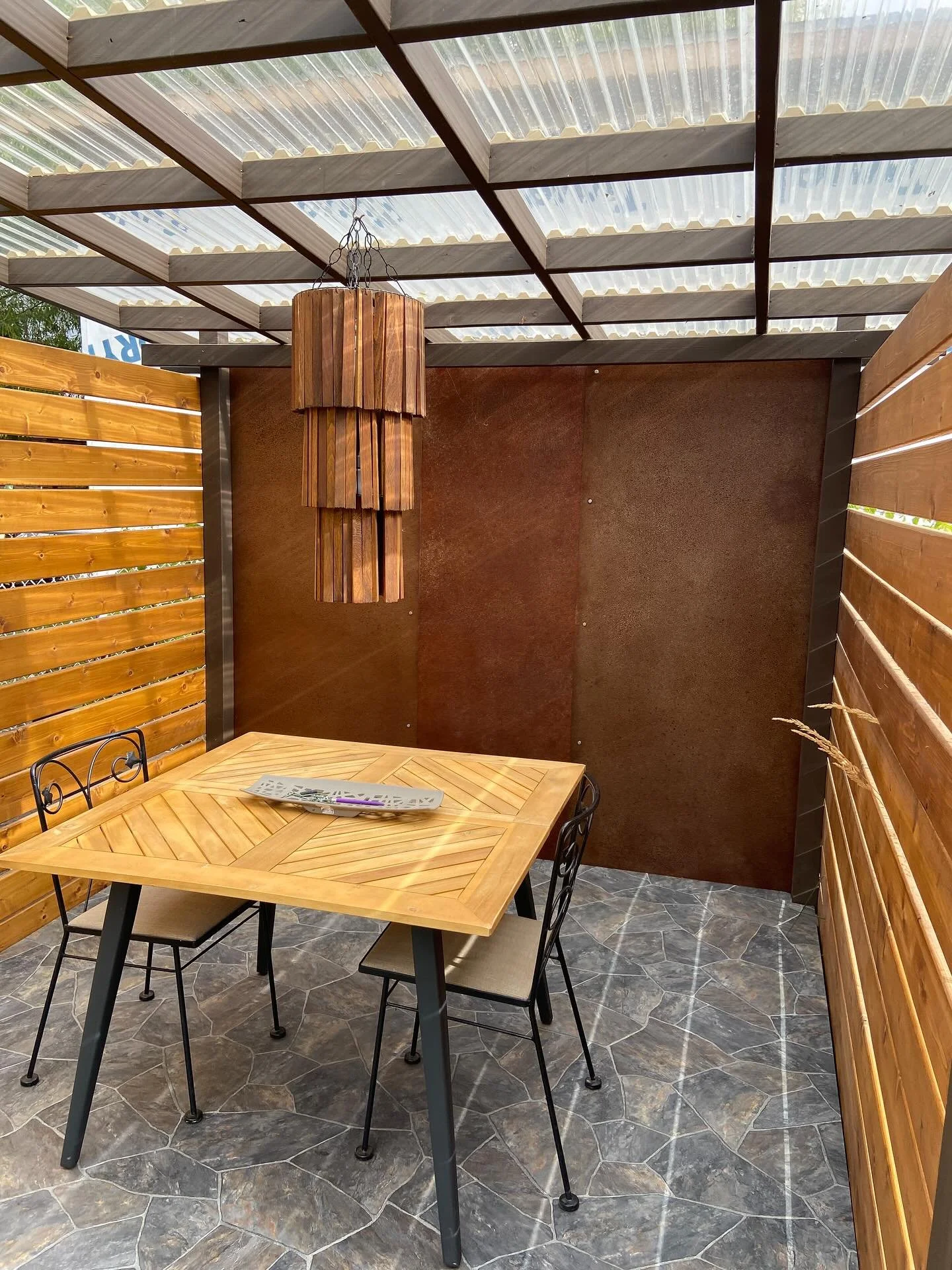 Rust done right. 
Beth loves the rusty aesthetic and wanted a statement wall for her outdoor nook.

I handled the steel work and installation &mdash; she took over the rusting and clear coat. Using her own mix, she brought the color to life and seale