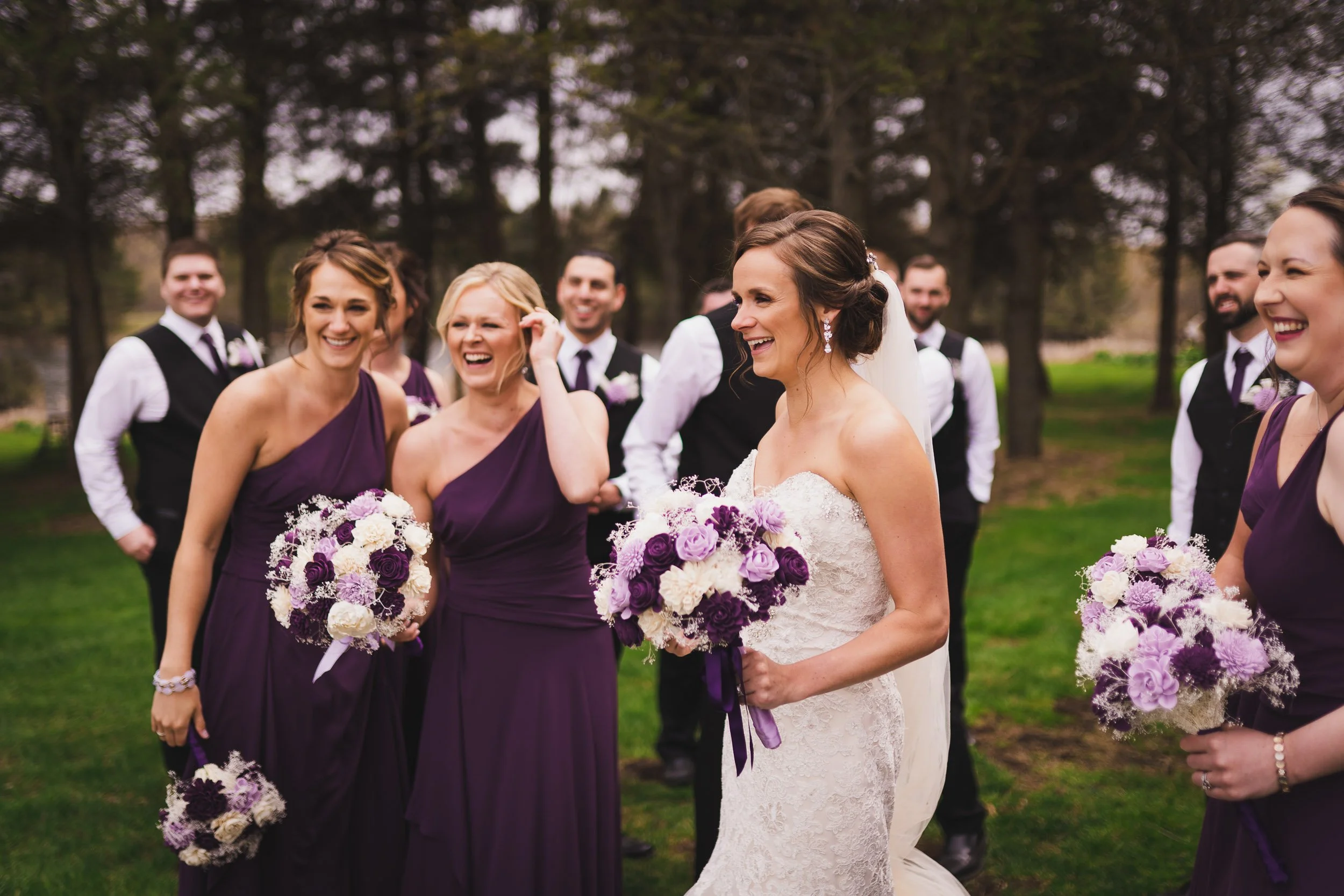 Bridesmaids and bride laughing together before ceremony