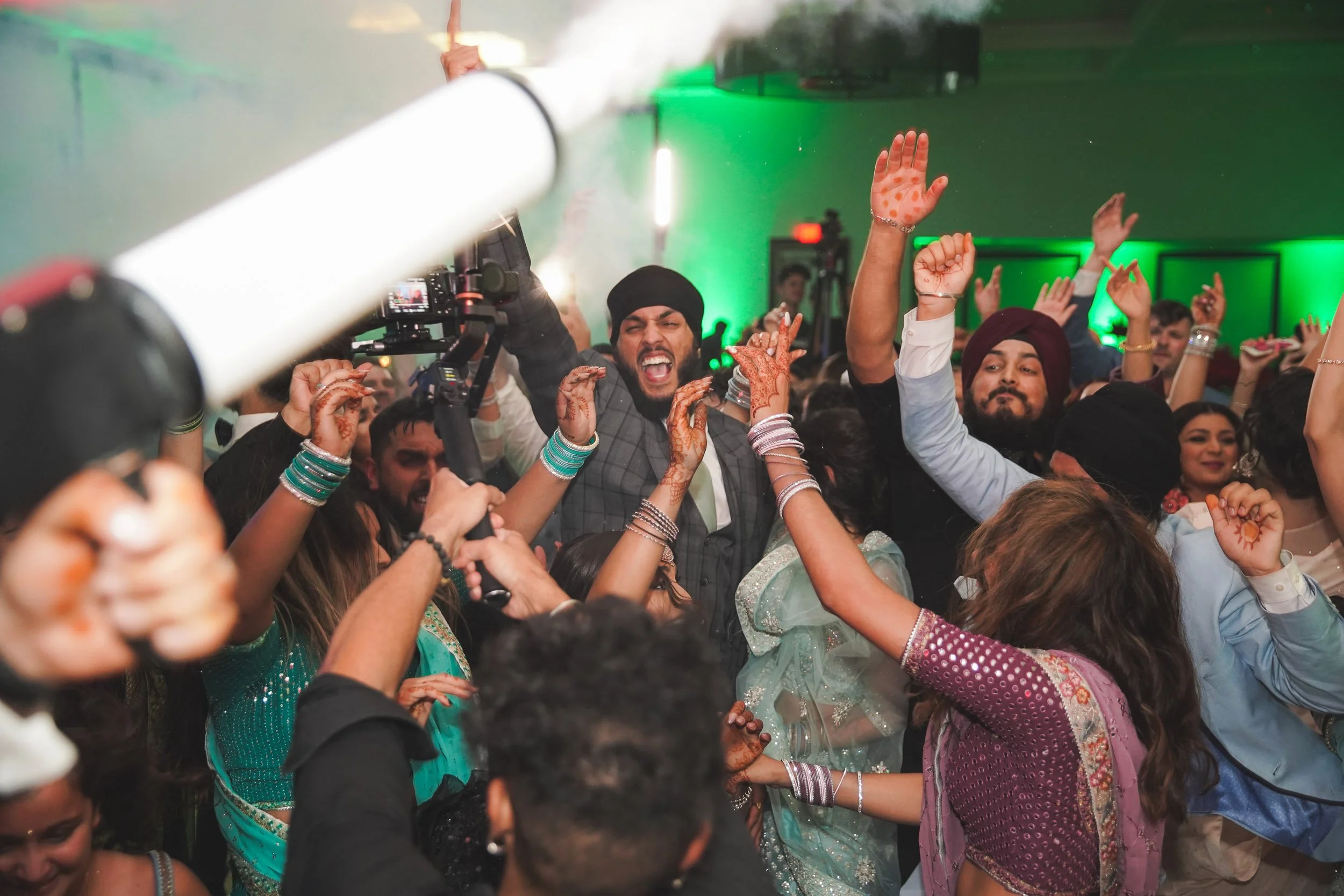 Wedding reception dance floor with guests celebrating
