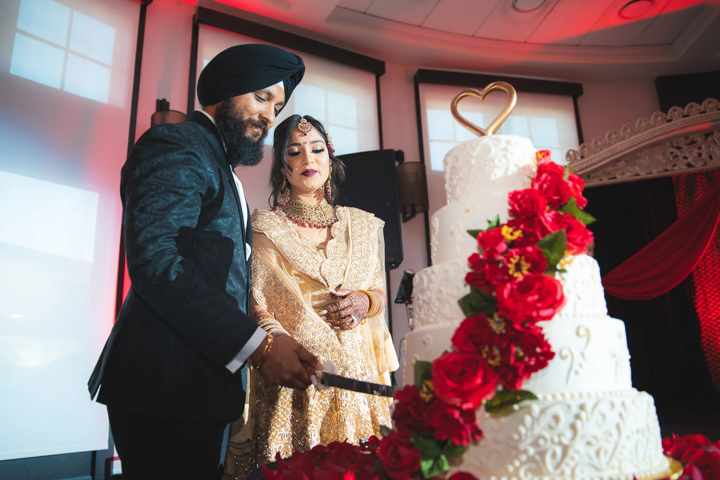 Couple cutting cake at wedding reception