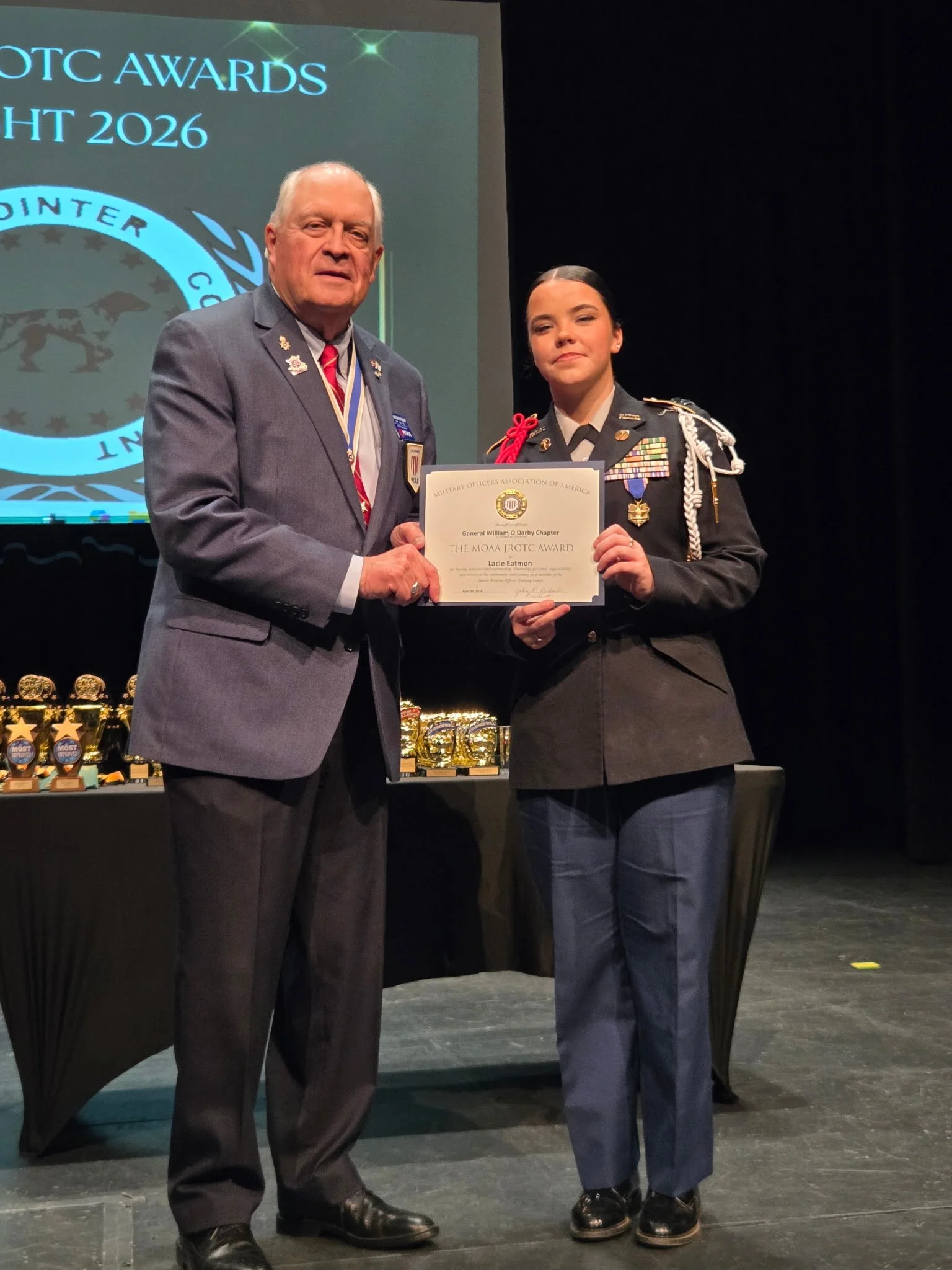 Man presents military award to JROTC cadet.