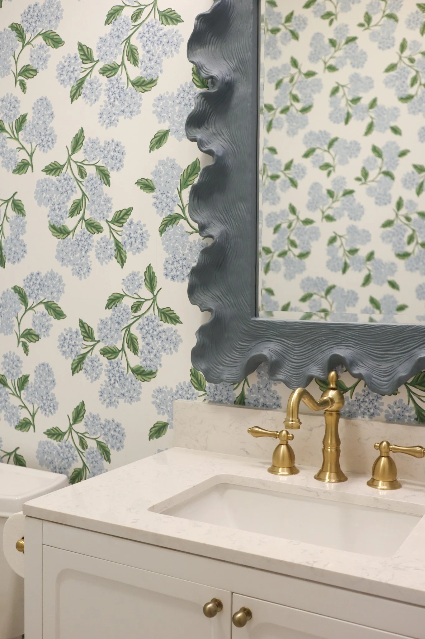 Nashville Bathroom Design with Hydrangea Wallpaper and Brass Accents