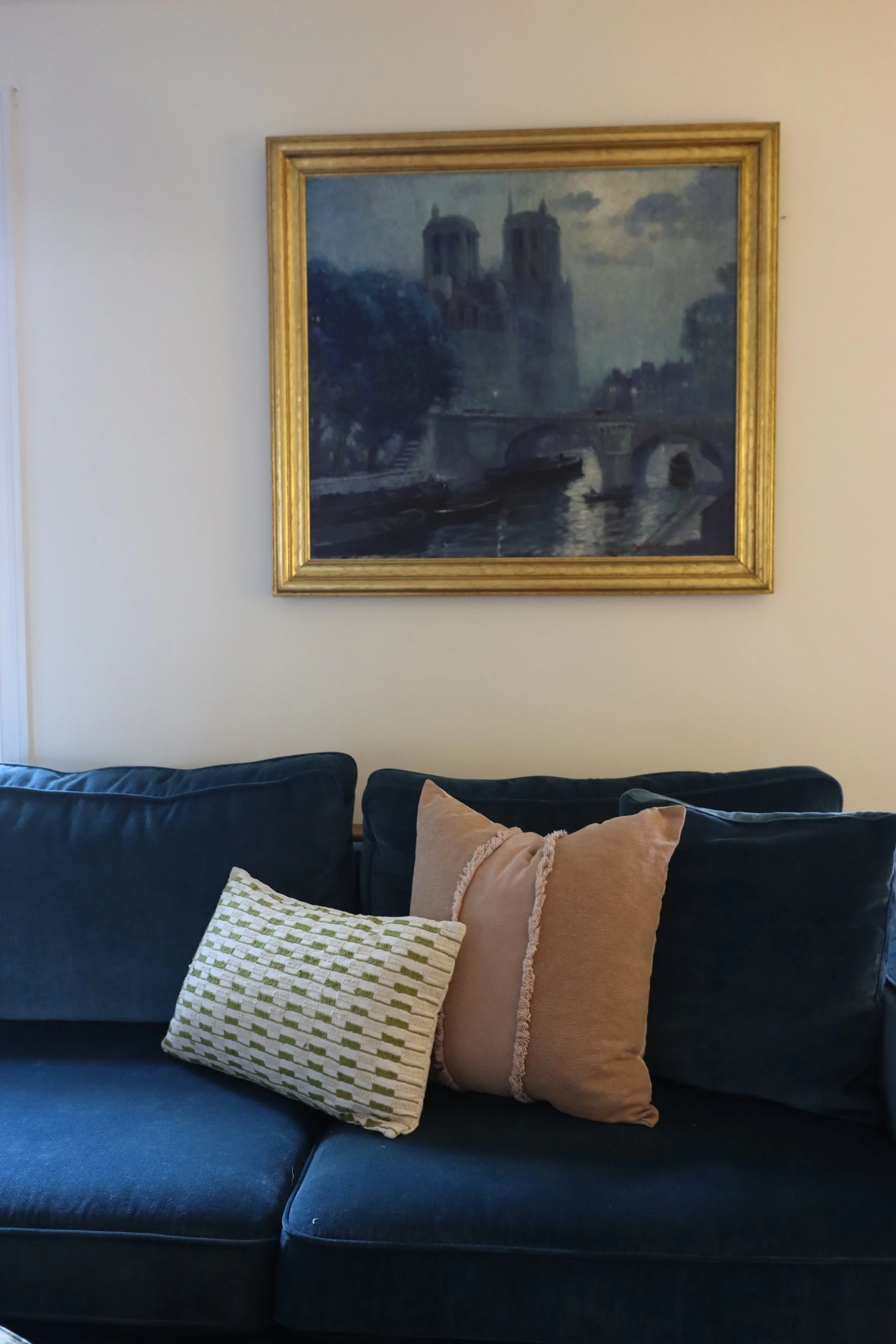 Layered living room seating arrangement featuring plush upholstery, textured pillows, and timeless furnishings.