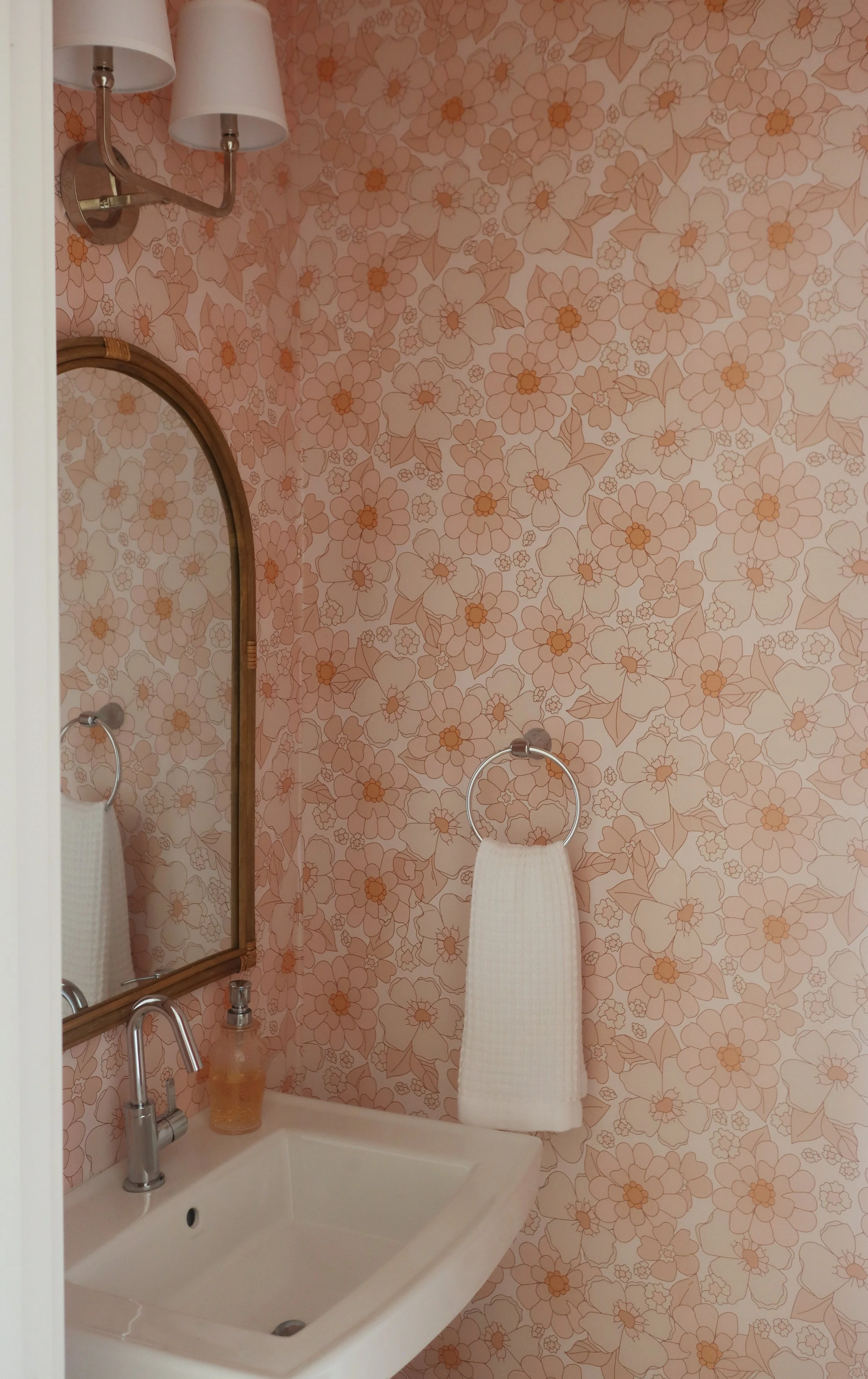 Pink Floral Powder Bath with Full-Wall Wallpaper and Retro 70's Style