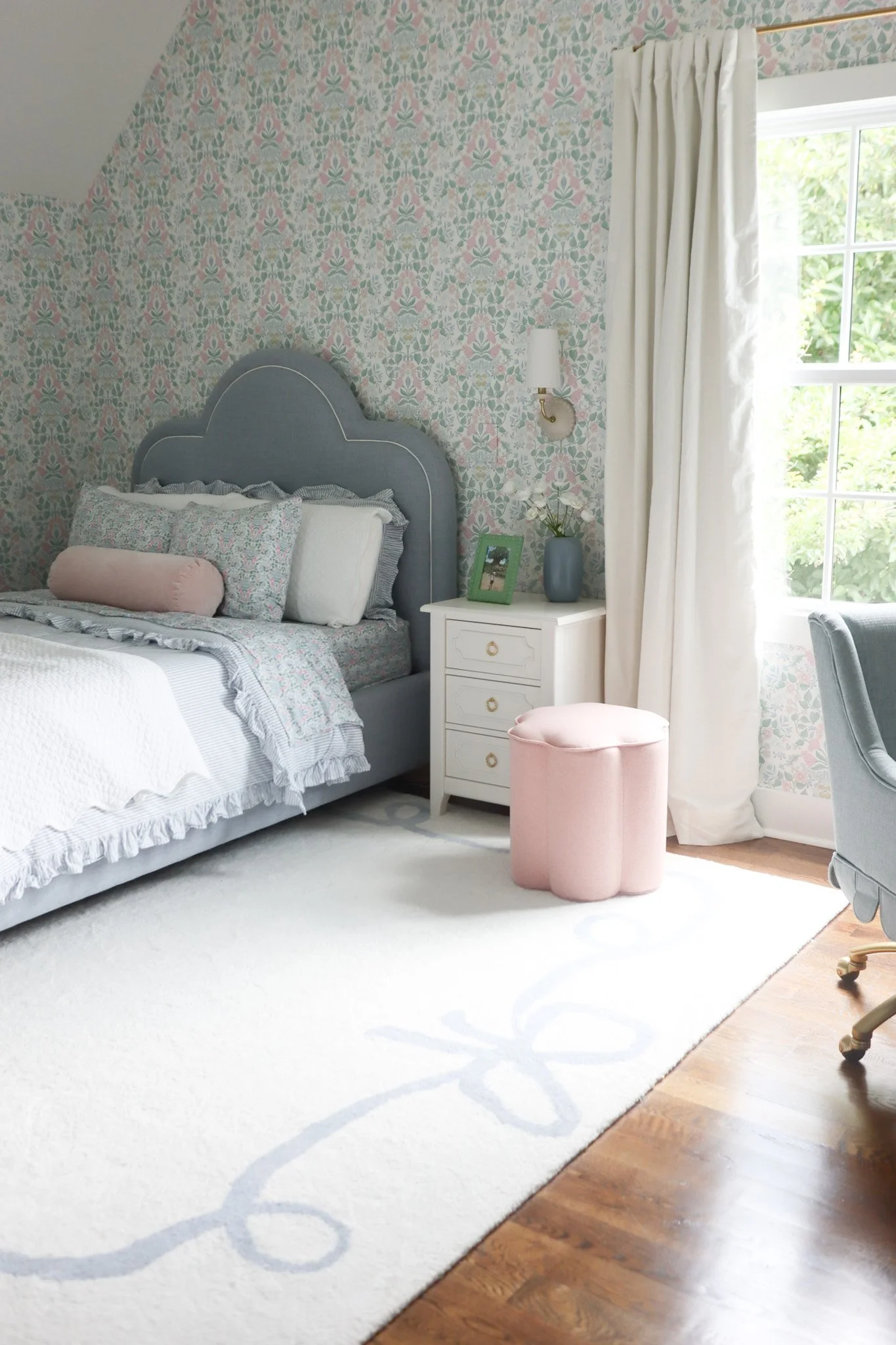Girls bedroom featuring floral wallpaper, soft colors, and a cozy, layered design in a Nashville interior design project.