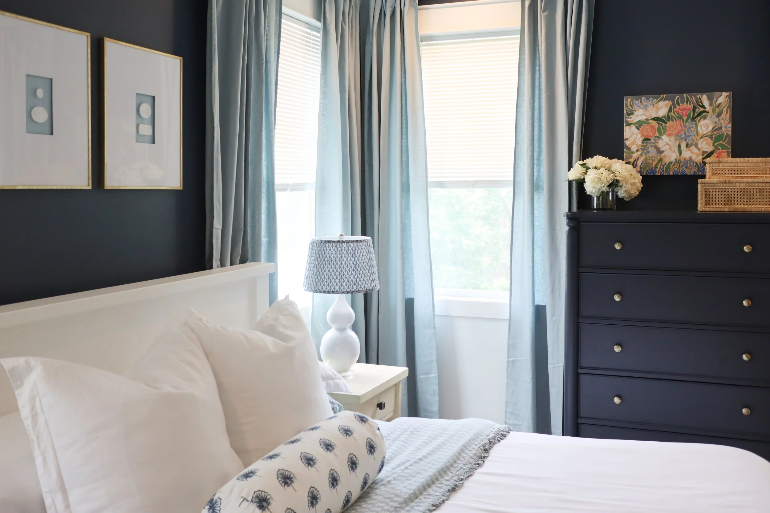 Traditional blue and white primary bedroom designed by a Nashville interior designer with layered indigo accents and classic styling.