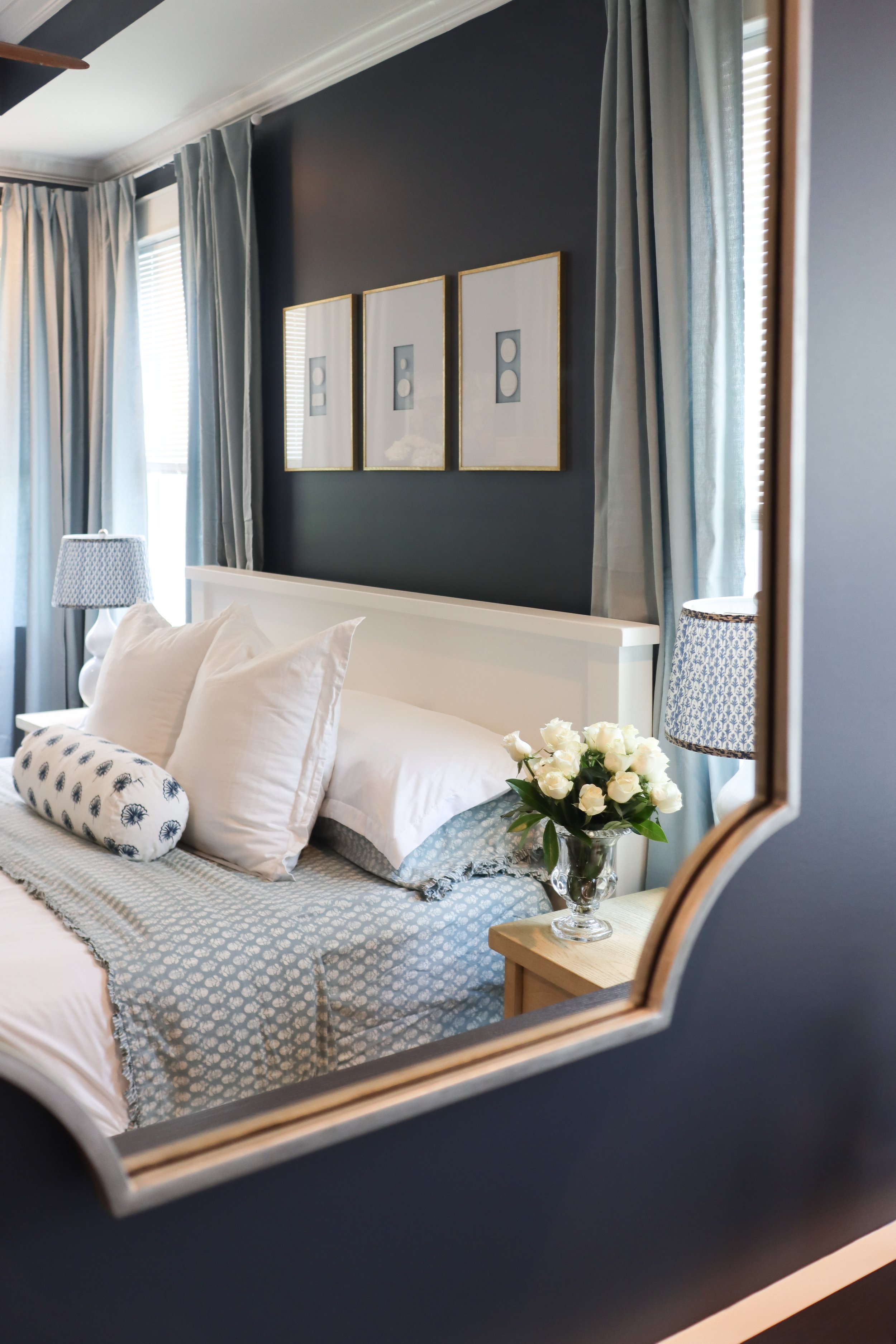 Sophisticated primary suite designed by a Nashville interior designer featuring navy, ivory, and traditional decor details.