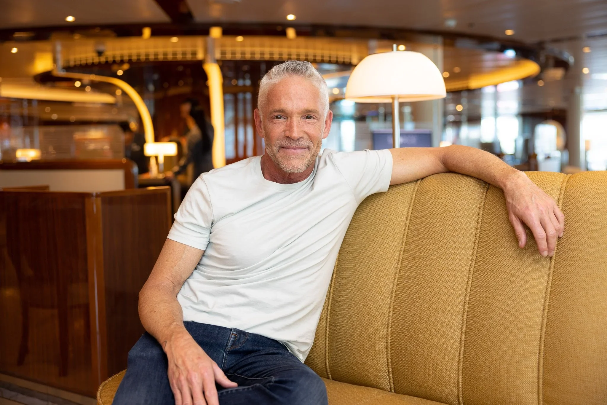 Dave Koz in a well-lit hotel lobby, smiling at the camera.