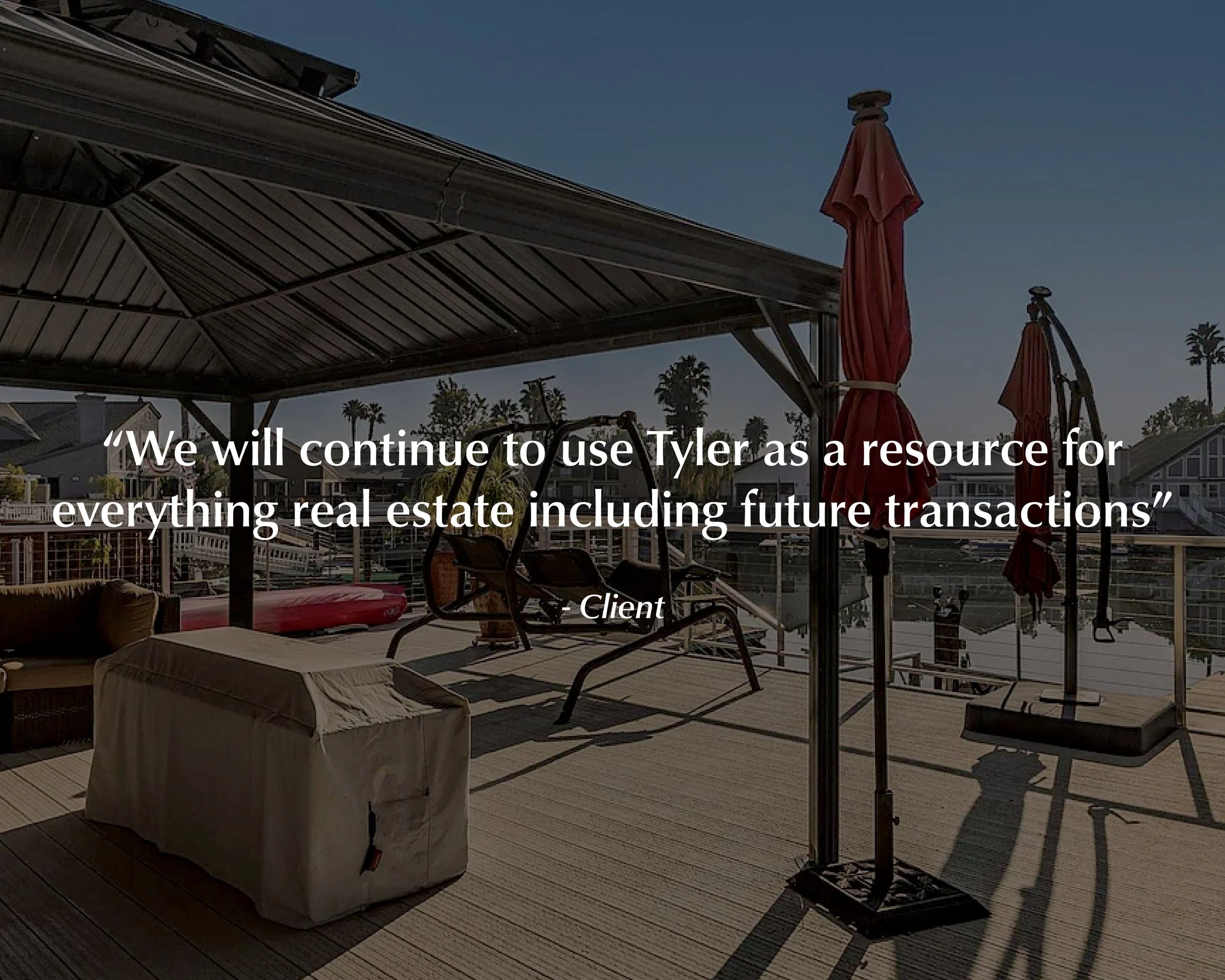 A deck with outdoor furniture, including umbrellas, chairs, and a covered object, overlooking a marina with houses and palm trees. A quote about using Tyler for real estate transactions is overlaid on the image.