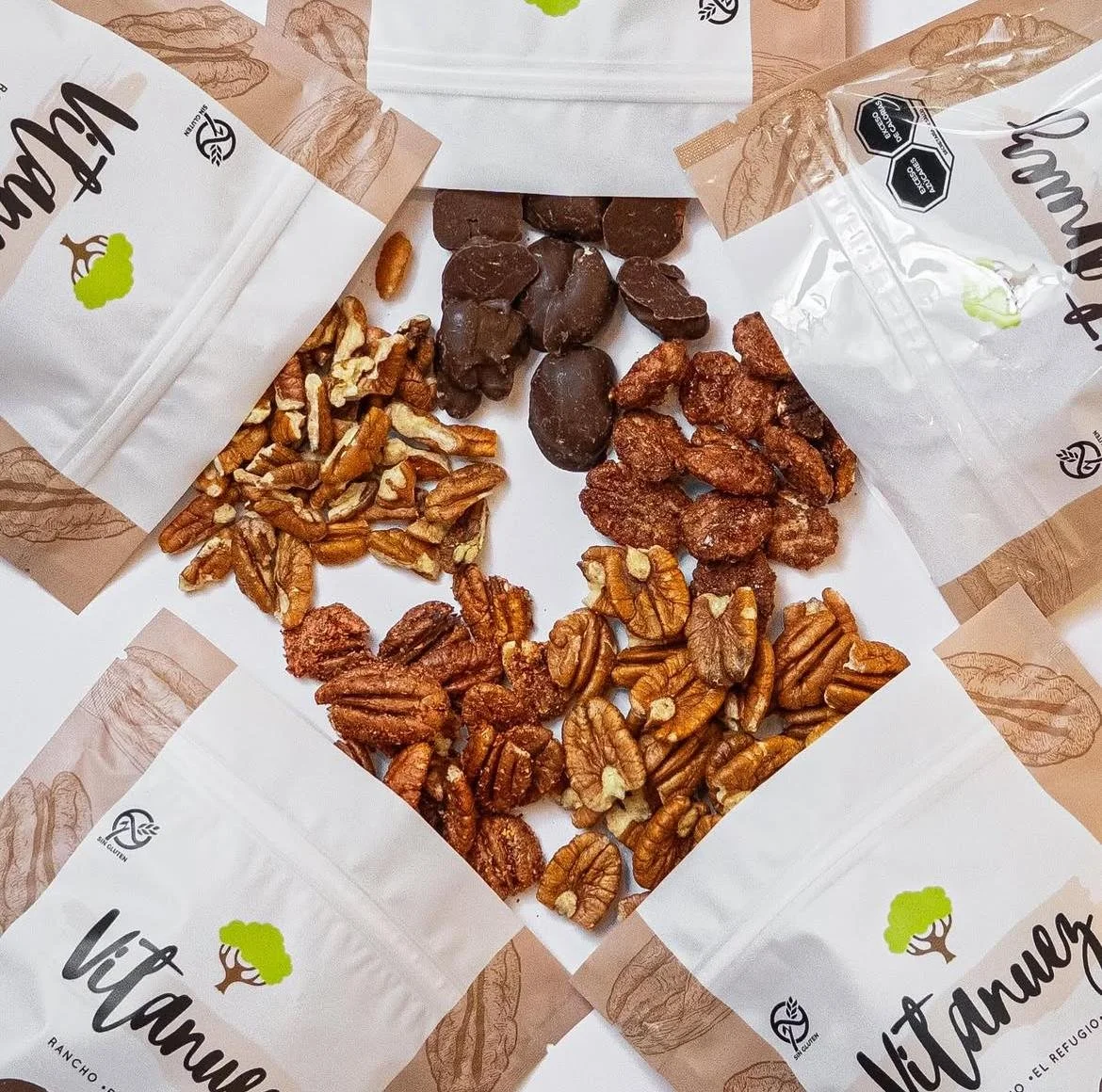 Assorted nuts and chocolates inside decorative packaging labeled 'Vitamania'.