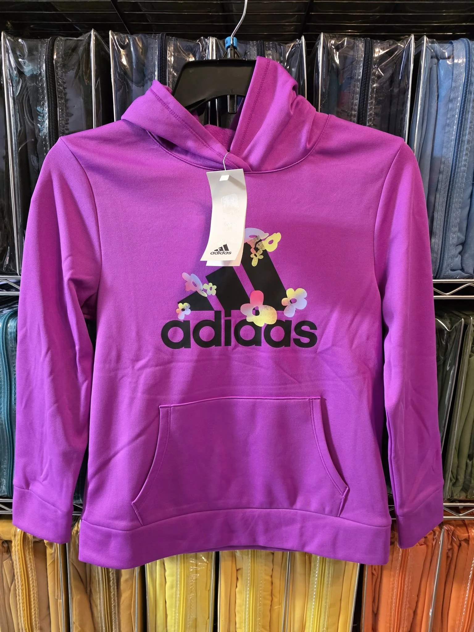 Purple Adidas hoodie on hanger, women’s sizes