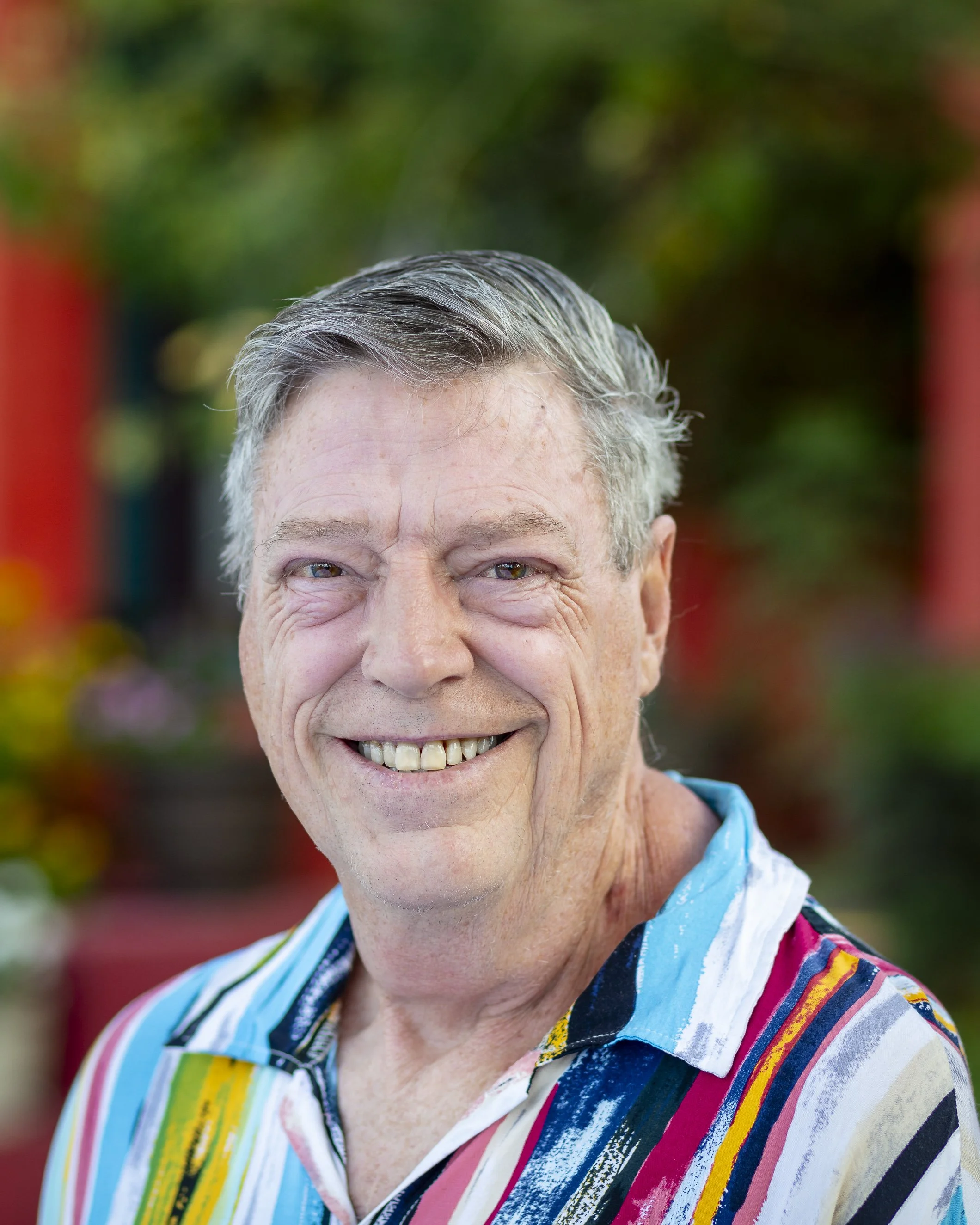 Dana Johnson smiling in a colorful shirt