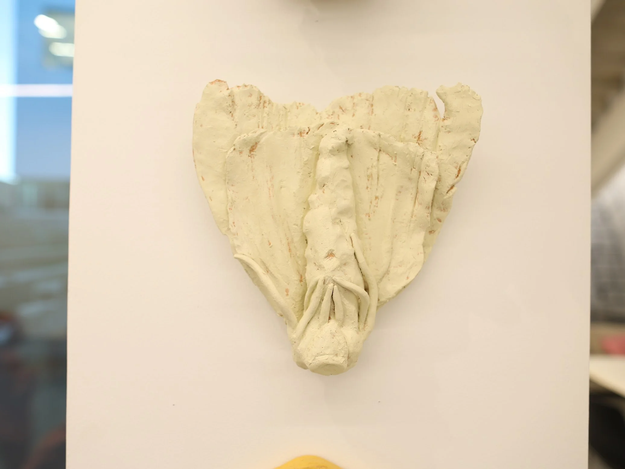 close up of "items", ceramic and house paint, 2025