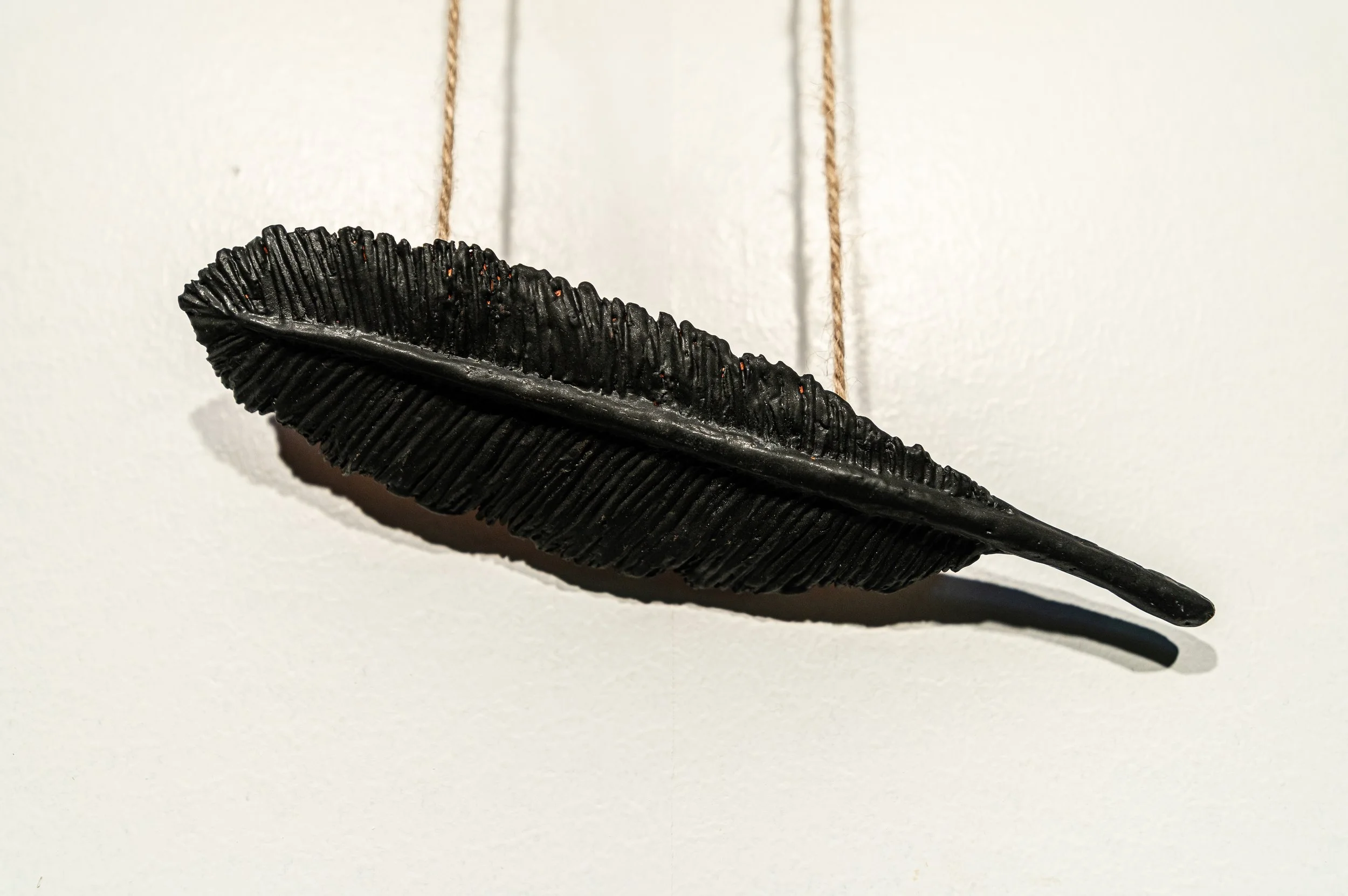 Feather, ceramic and acrylic painting on angrie wood, H15" x W11", 2026