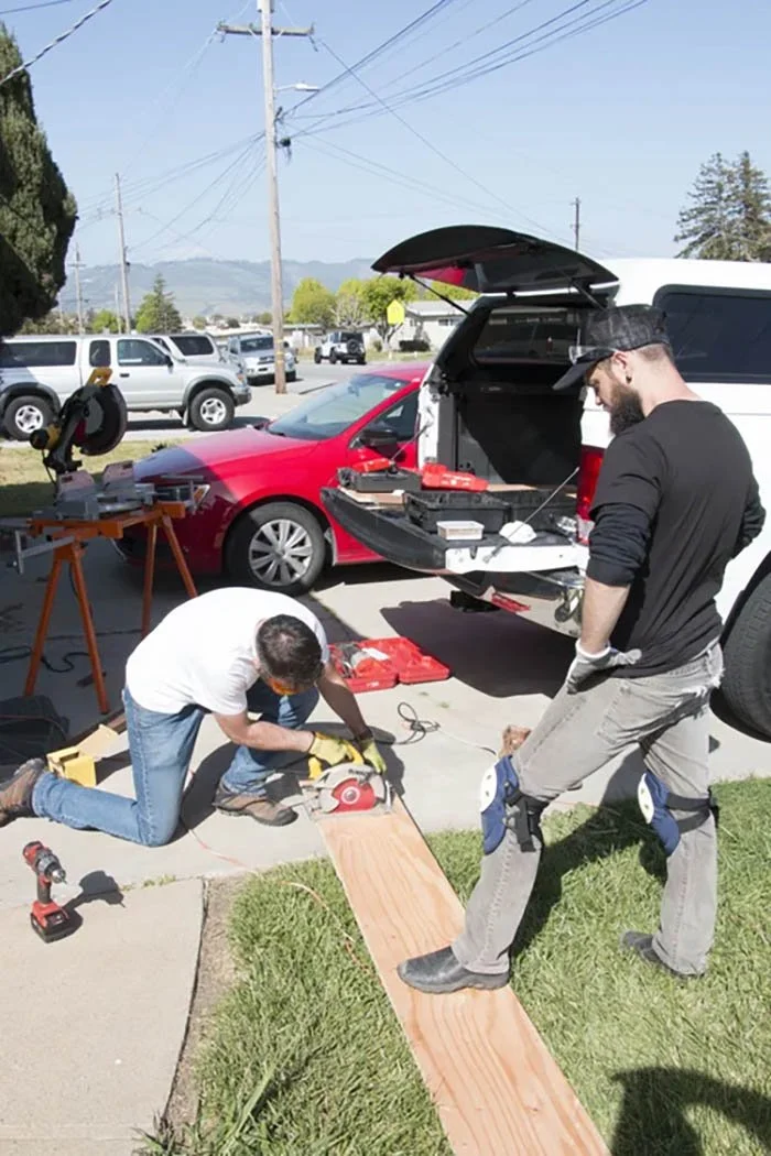 Volunteers building a ramp to help a veteran.