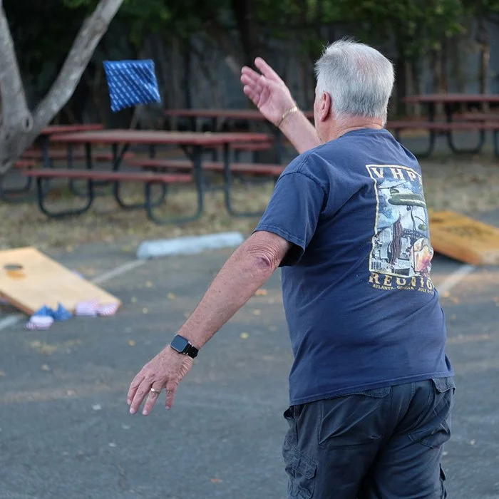 Member playing cornhole