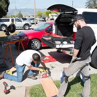 Volunteers building a ramp to help a veteran.