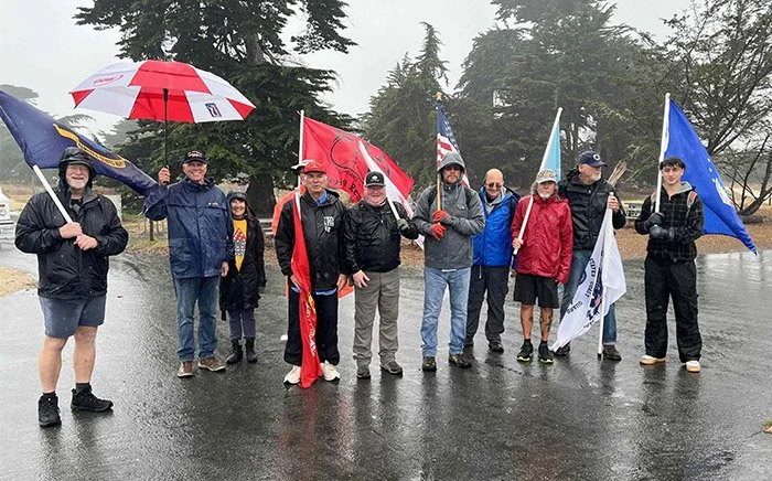 Group holding flags for 2024 veterans day walk
