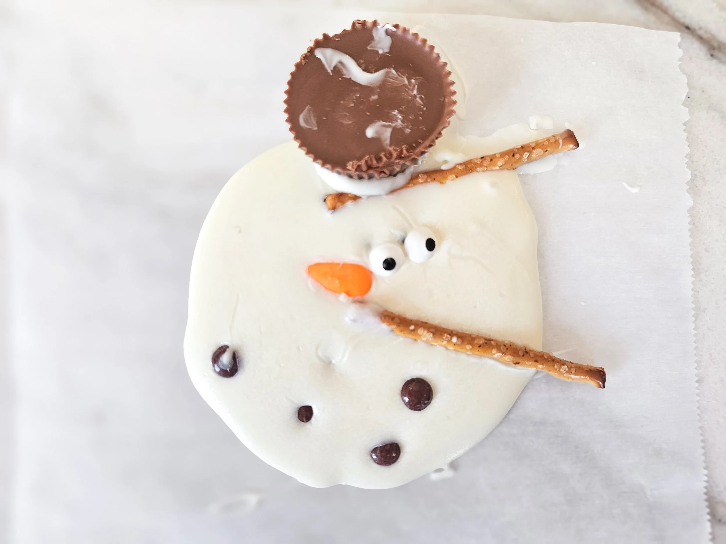 Our snowman melted into sweet delicious chaos! 😄⛄🍫🥨